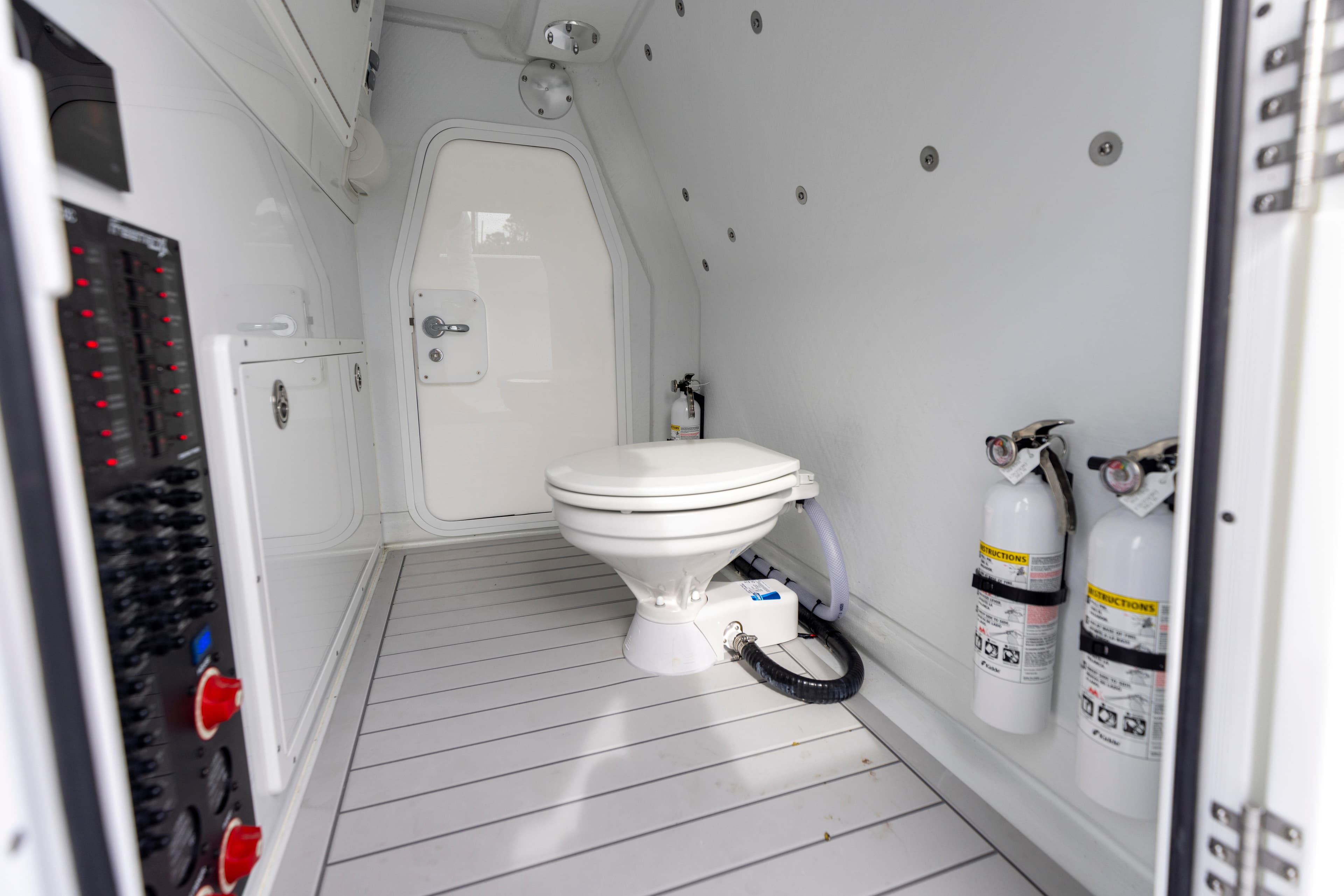 2024 Freeman 42 LR boat interior with toilet and fire extinguishers.