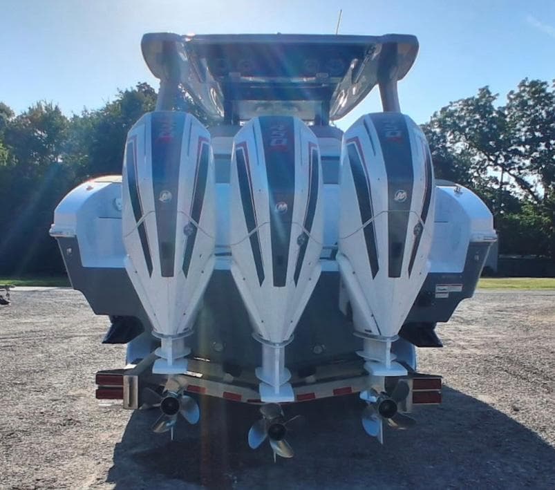2023 Fountain 38 SCX boat with triple outboard engines, rear view.