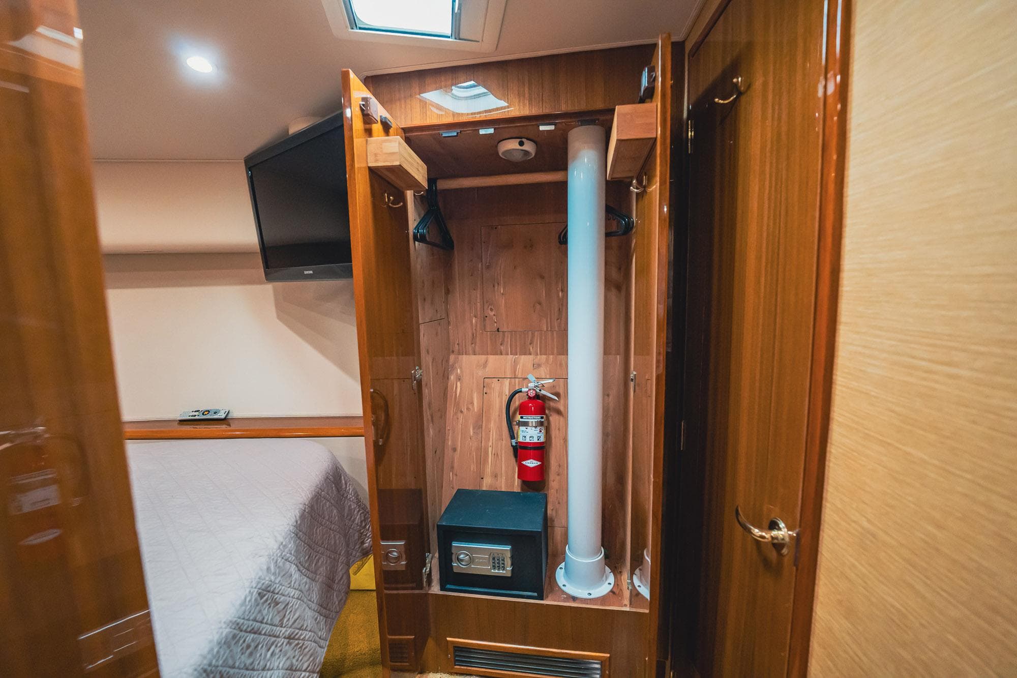 2005 Viking 48 Convertible interior with closet, safe, and fire extinguisher.