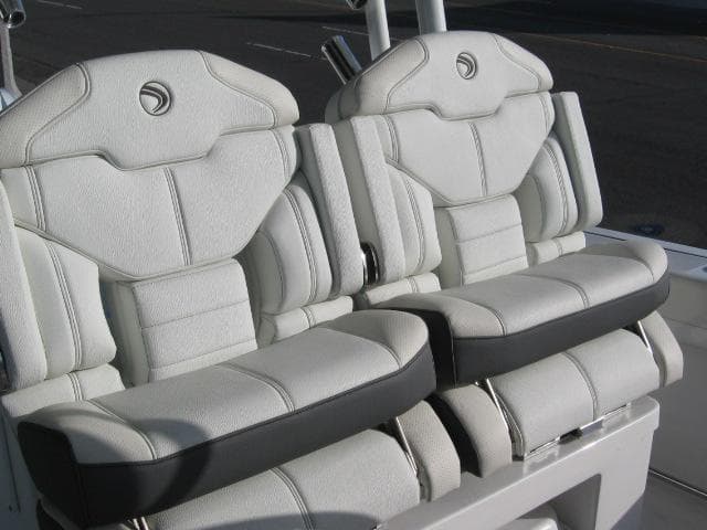 2024 Edgewater 325 CC boat seats, white leather upholstery, dual seating.