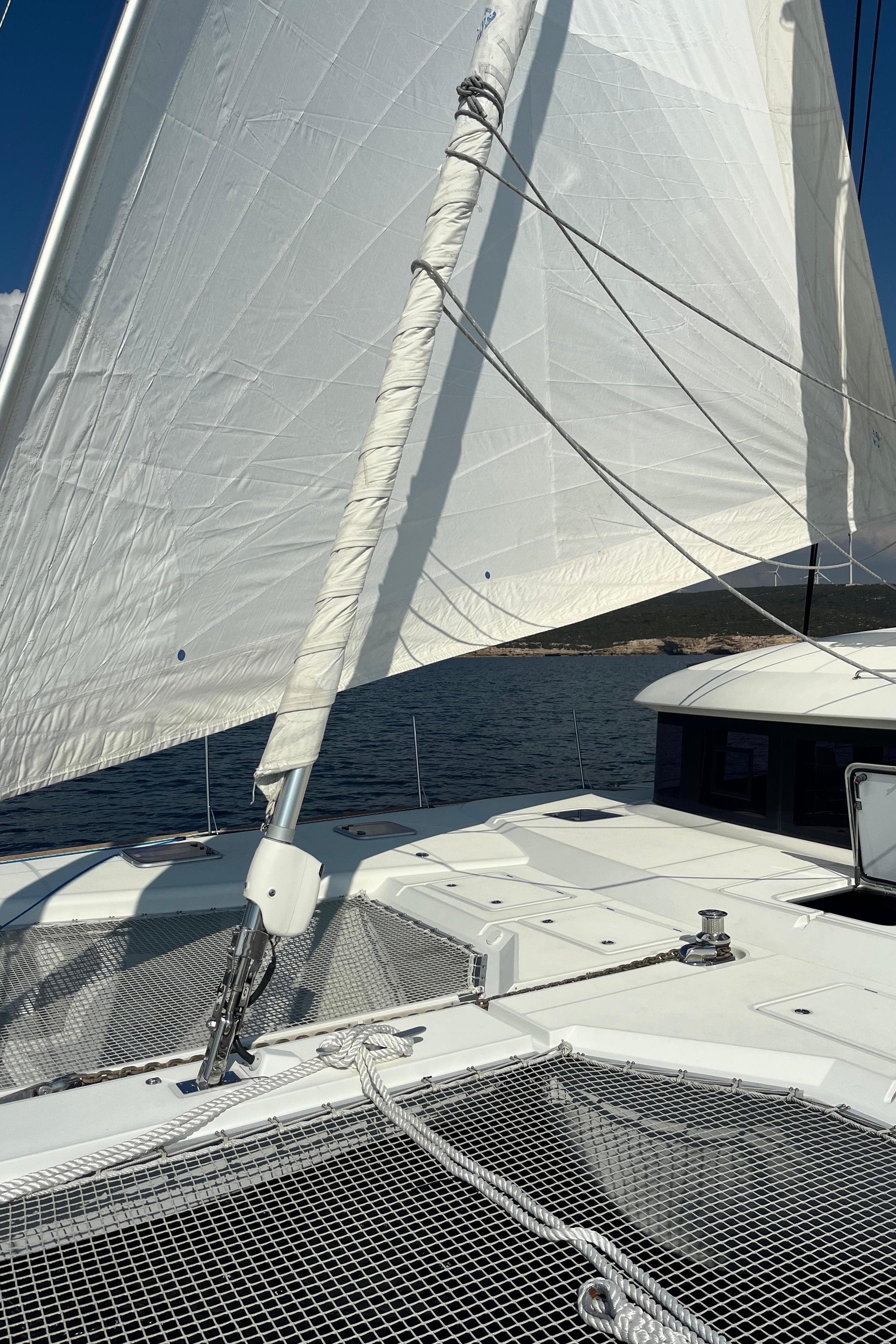 Sailing yacht Lagoon 620 Essence 2017 with sails up on open water.
