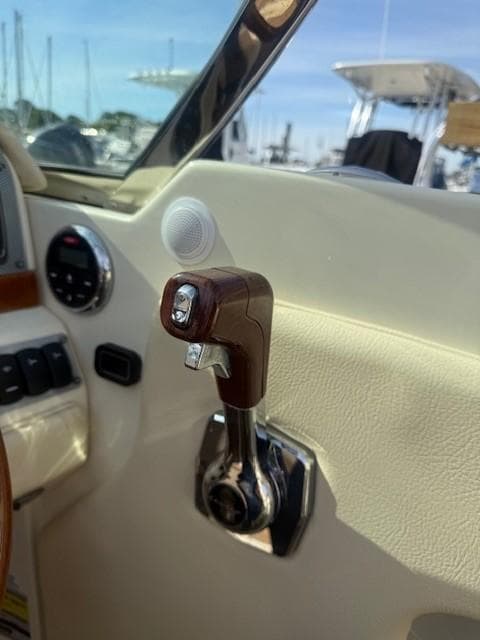 2014 Chris-Craft Launch 25 throttle control in a boat cockpit, showcasing luxury design.