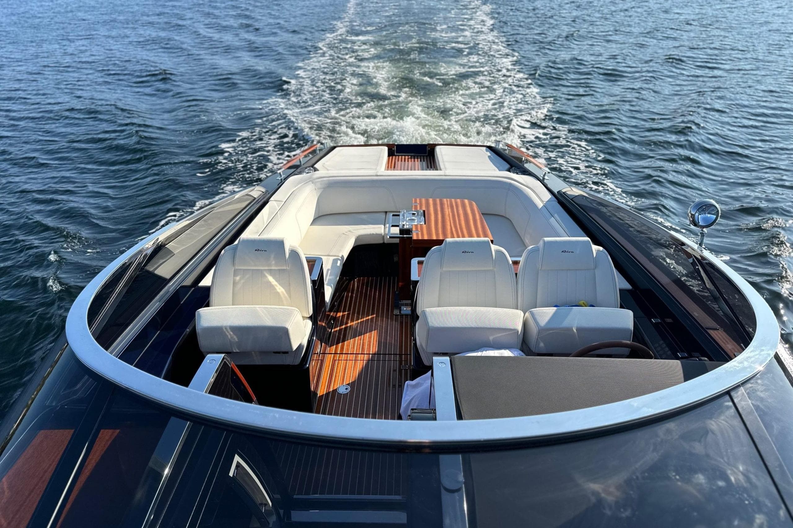 Luxurious 2021 Riva 38 Rivamare yacht cruising on open water, featuring elegant seating and sleek design.