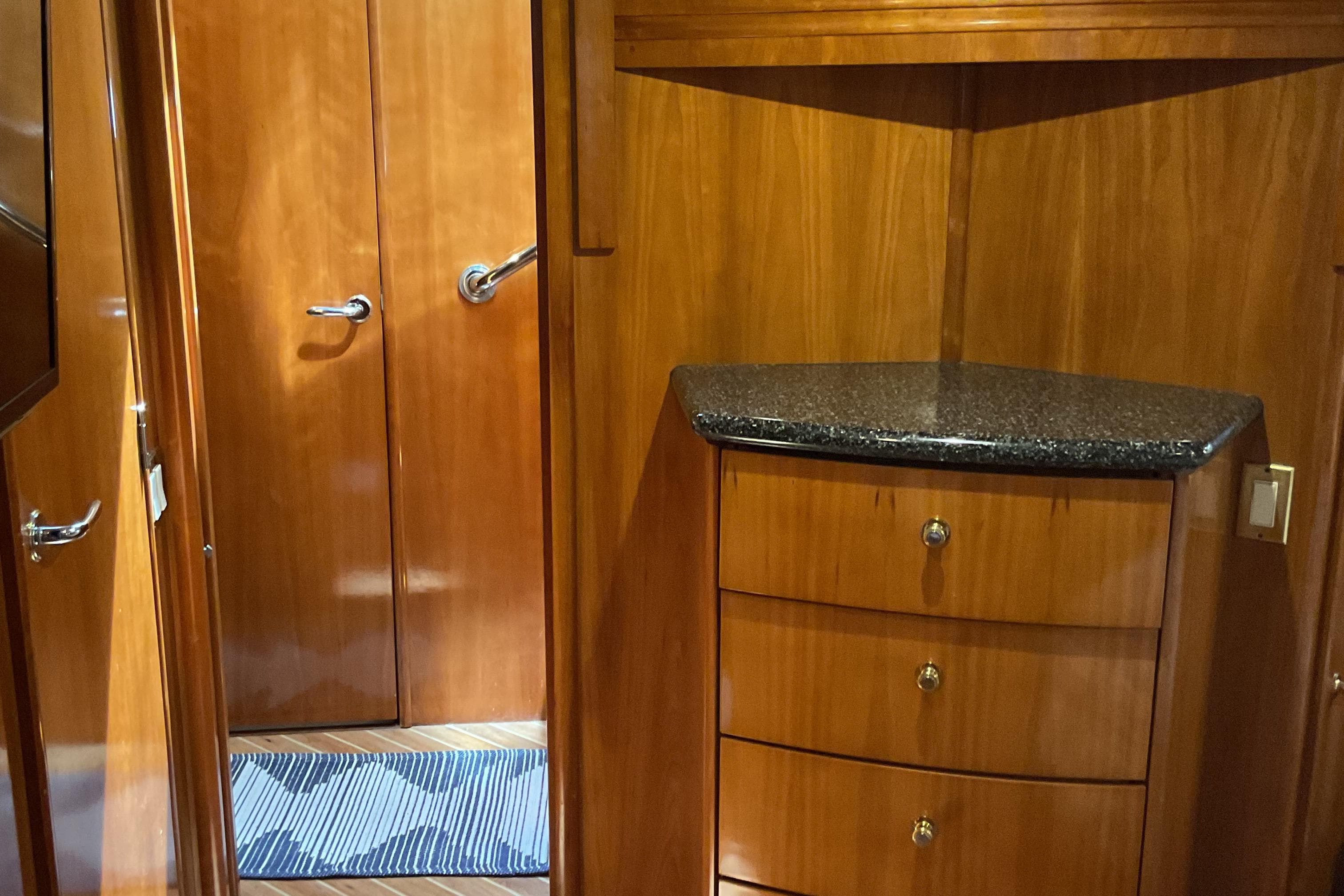 Interior of 2000 Carver 530 Voyager Pilothouse with wooden cabinetry and granite countertop.