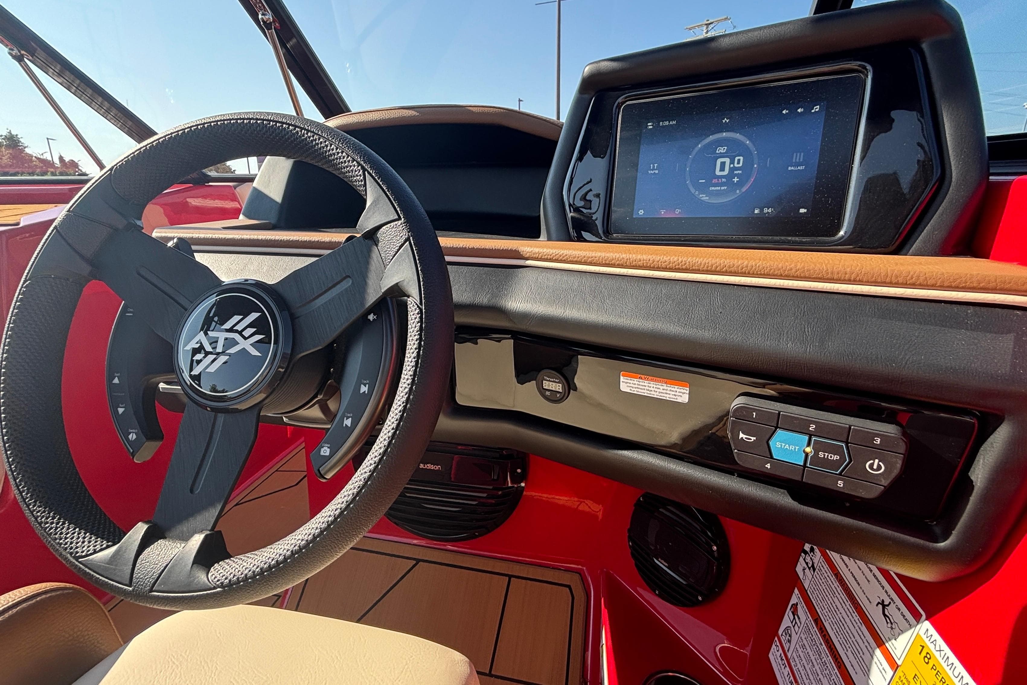 2026 ATX Surf Boats 24 Type-S dashboard with steering wheel and touchscreen display.