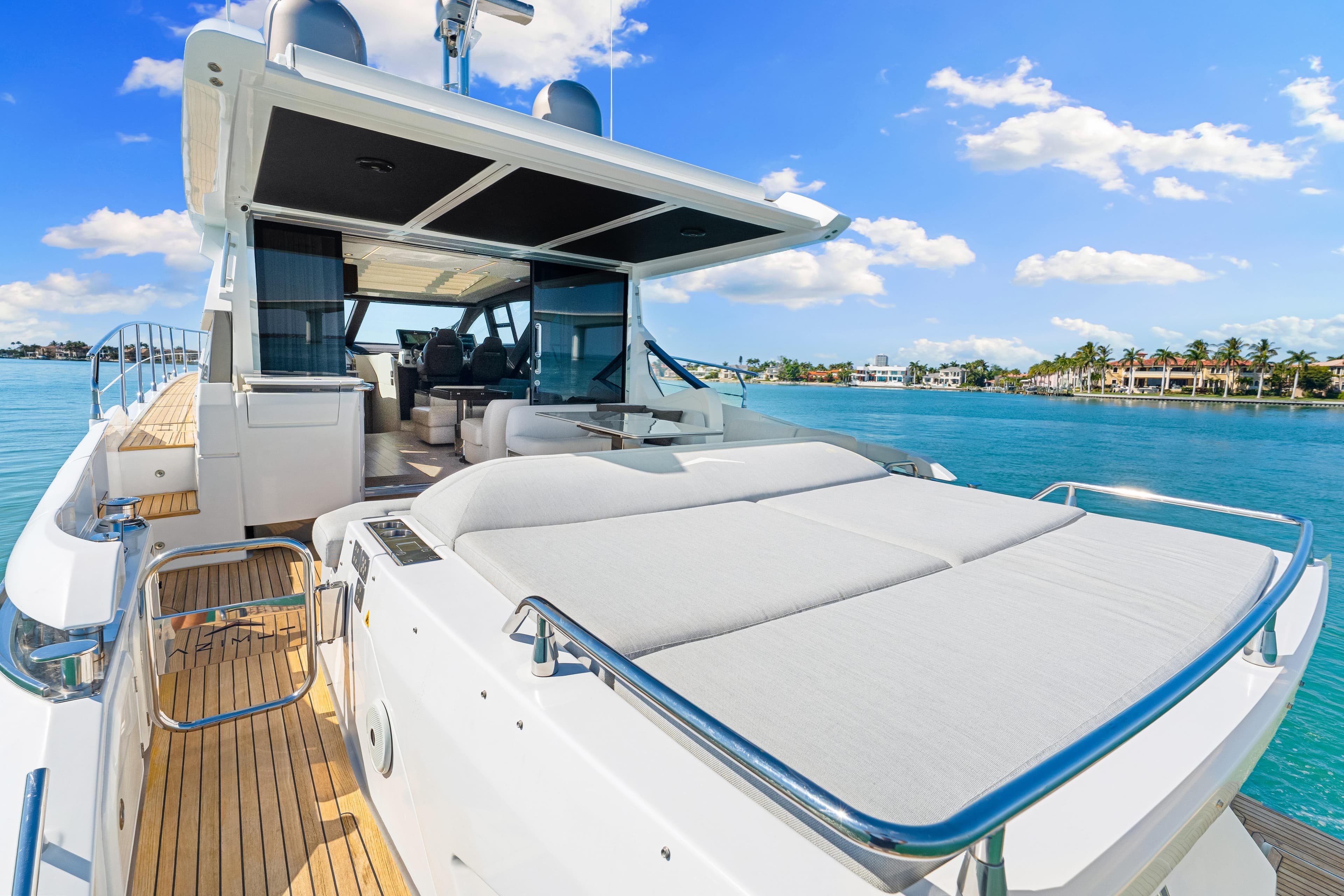Luxurious 2020 Azimut S6 yacht with spacious deck, cruising on clear blue waters.