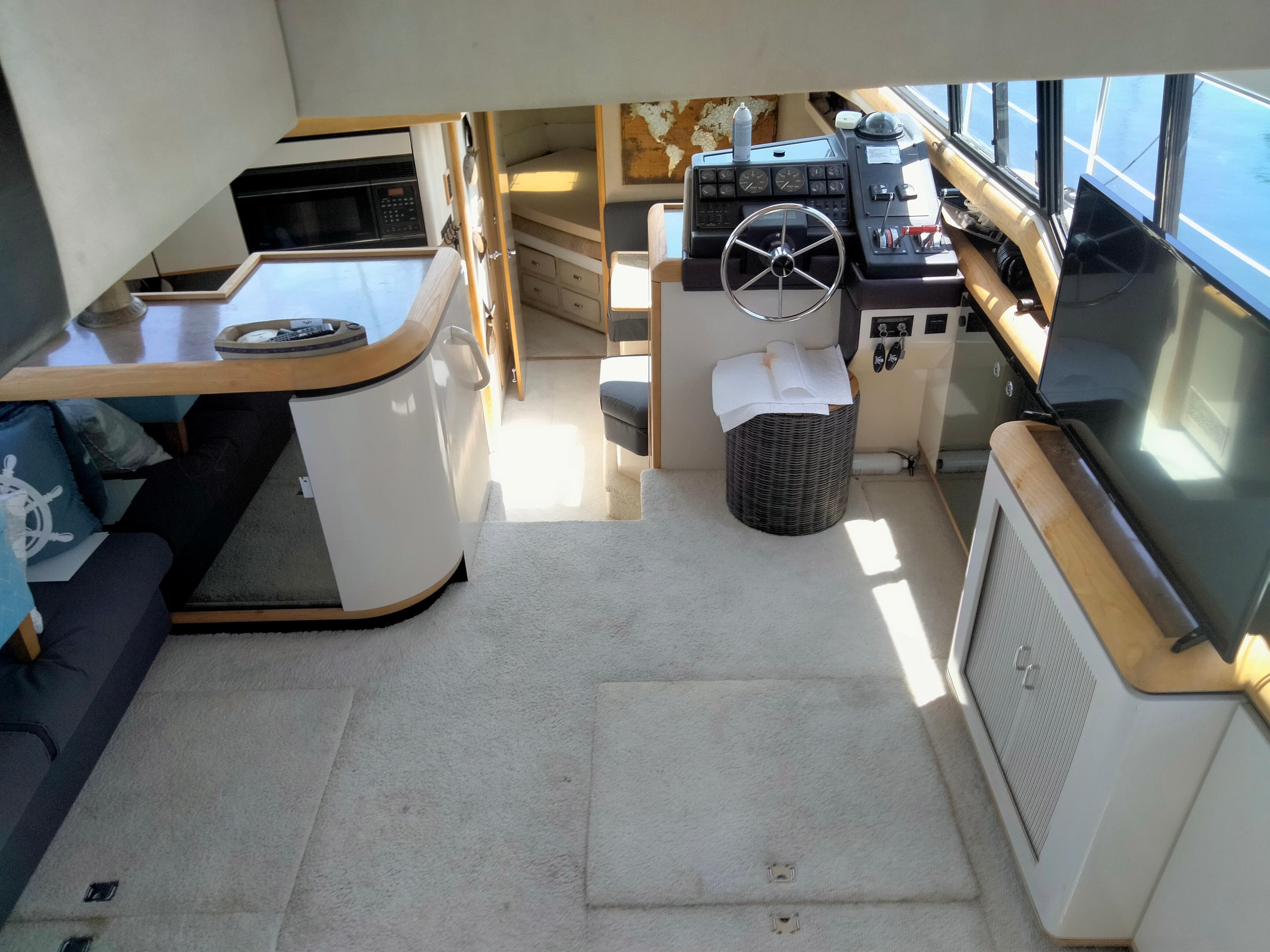 1990 Bayliner 4387 Aft Cabin interior with helm, seating, and modern amenities.