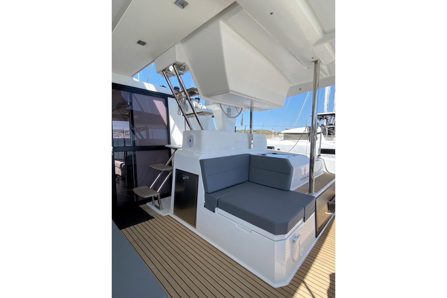 2021 Fountaine Pajot Catamaran Astrea 42 interior with seating and stairs, featuring modern design.