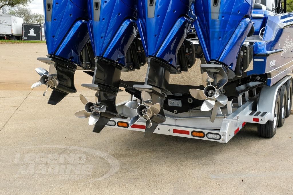 2023 Nor-Tech 390 Sport Center Console with triple outboard engines on trailer.