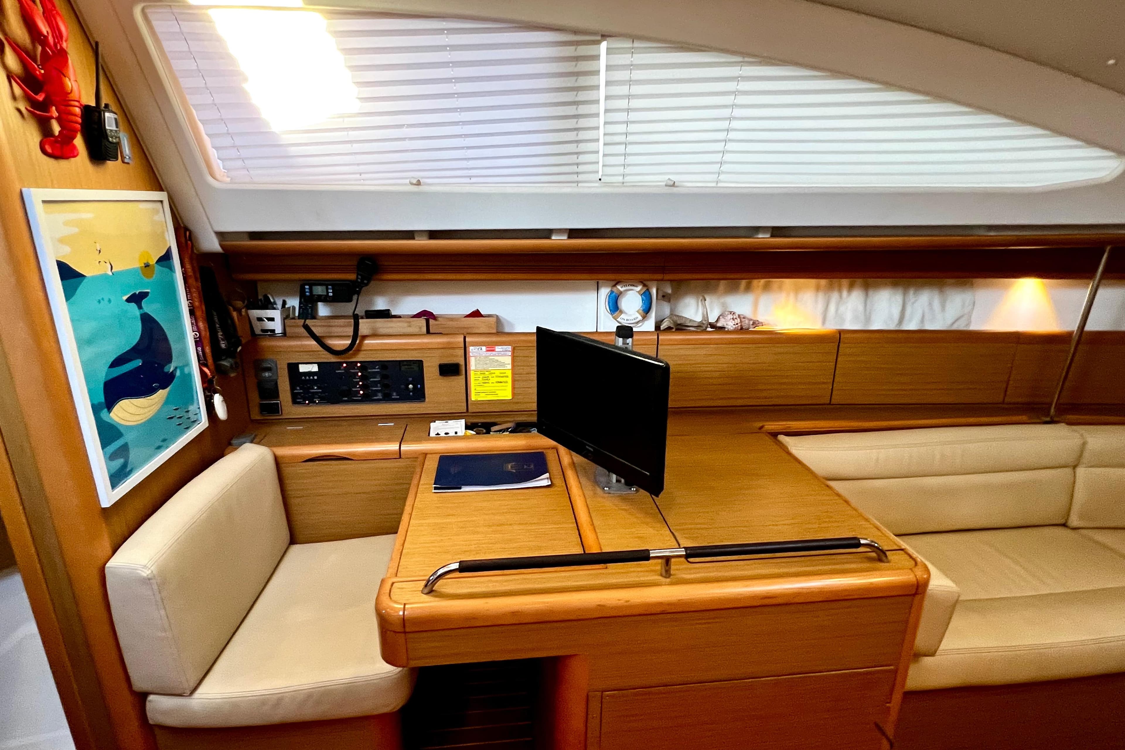 Interior of 2008 Jeanneau Sun Odyssey 45 DS sailboat with navigation station and seating area.