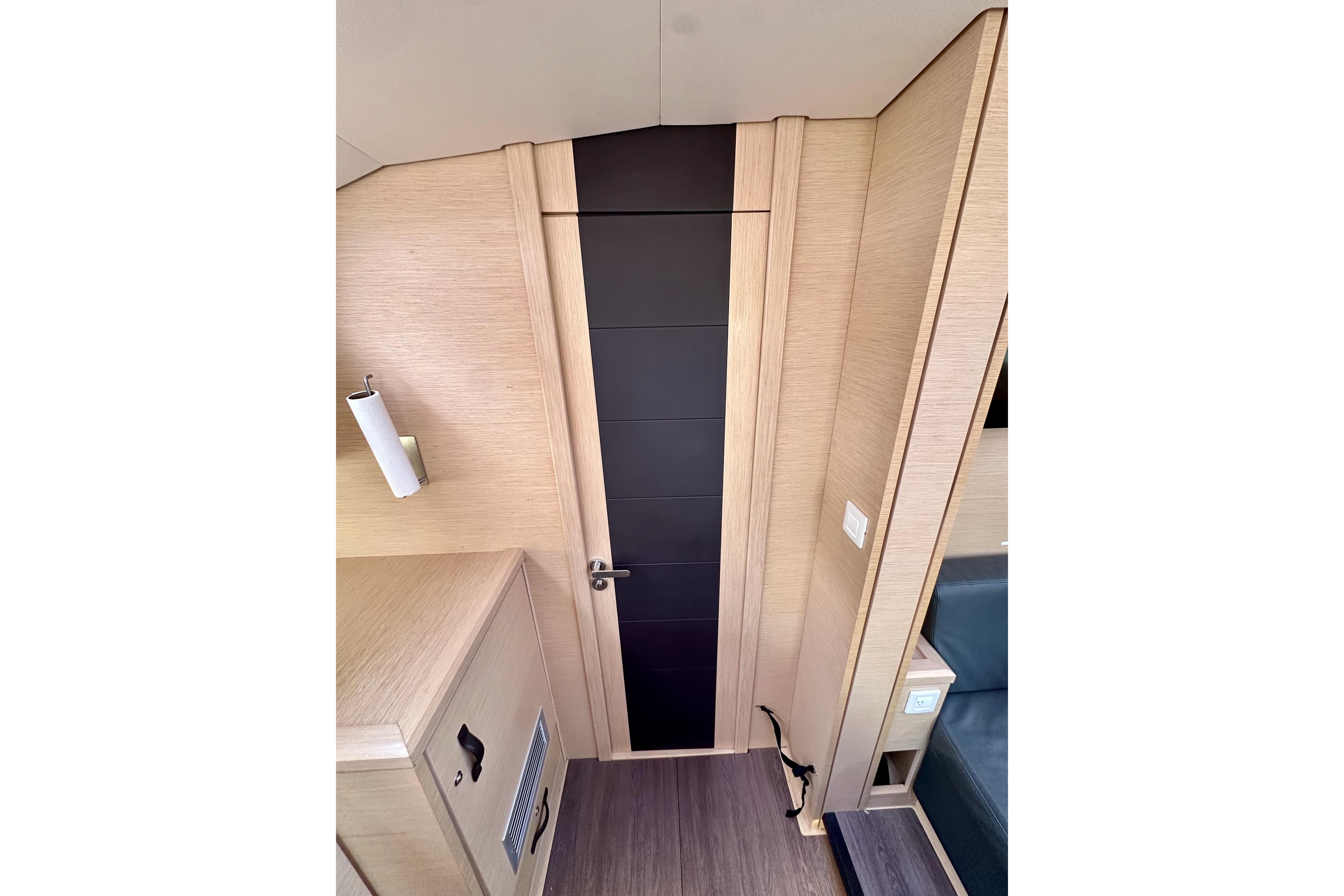Interior of 2018 Jeanneau 54 yacht, featuring sleek wooden paneling and modern design elements.