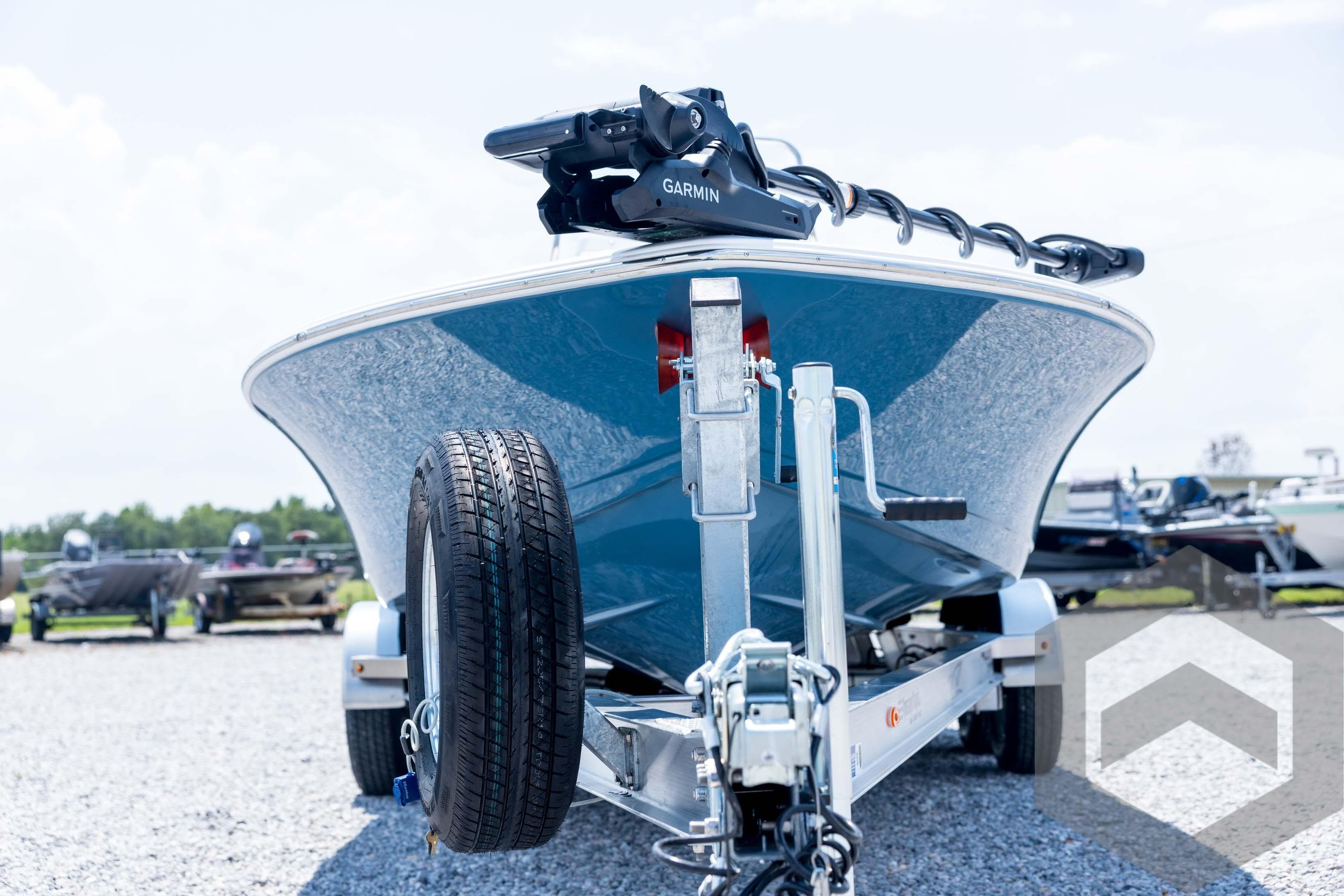 2026 Tidewater 2110 Bay Max boat on trailer, featuring Garmin equipment, parked outdoors.