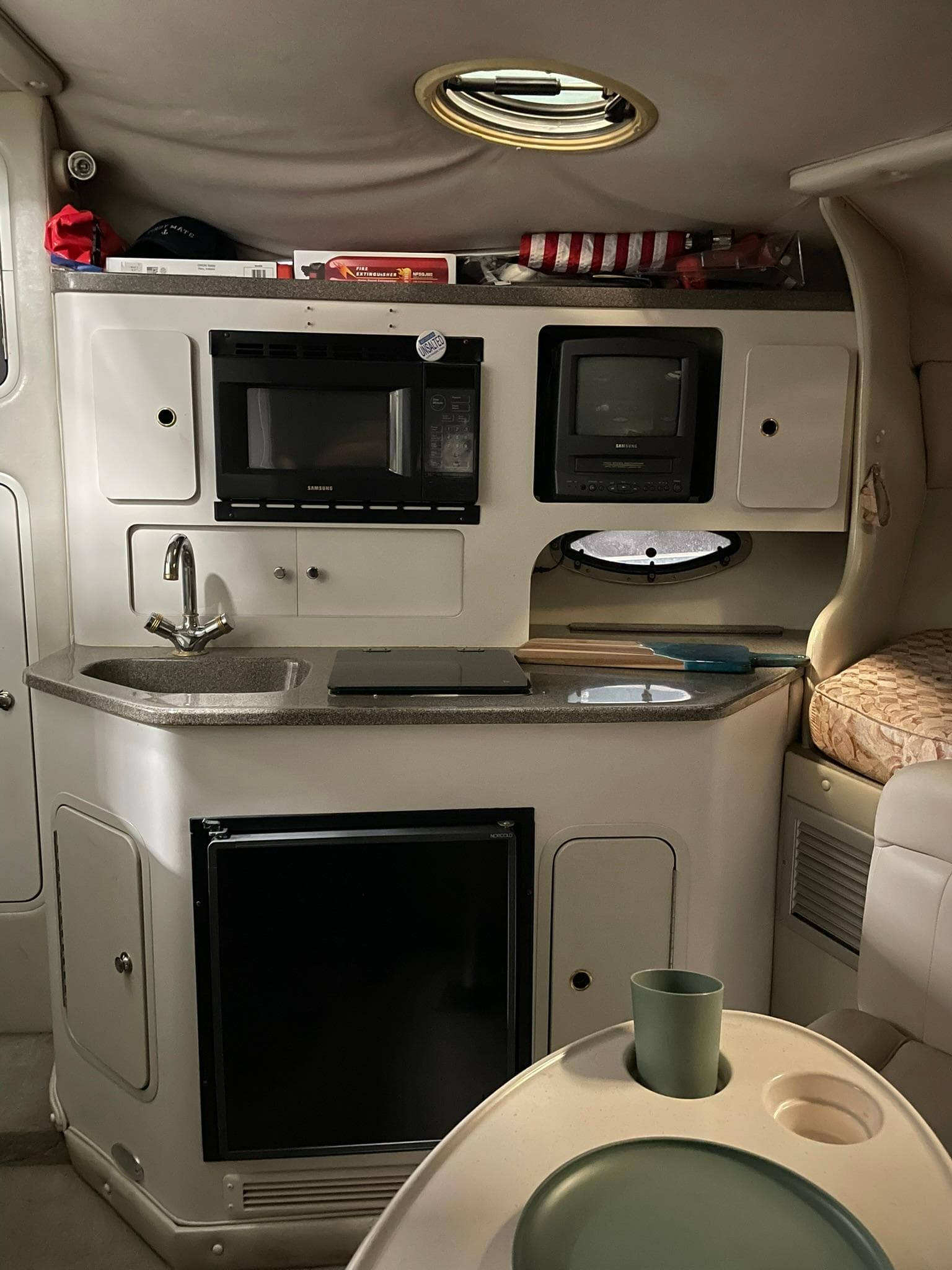 Interior of 2000 Crownline 290 CR boat with kitchenette and seating area.