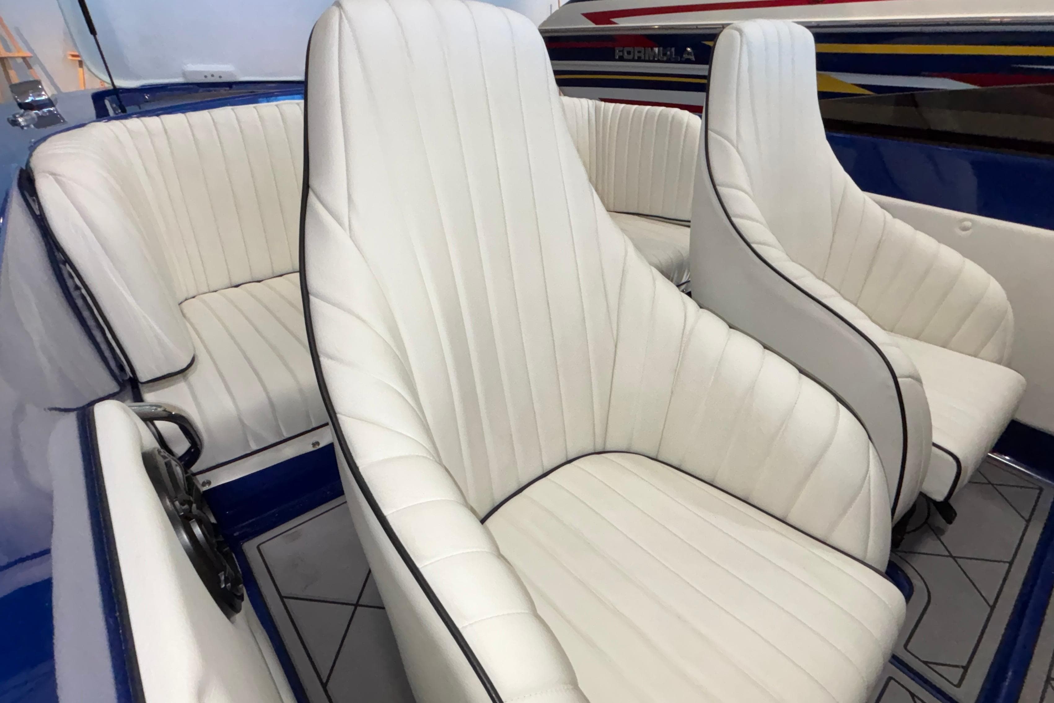 2026 Donzi 22 Classic boat interior with white leather seats and blue accents.