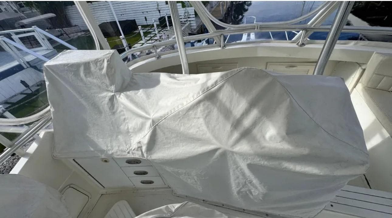 1987 Blackfin Convertible boat interior with covered seating and controls.