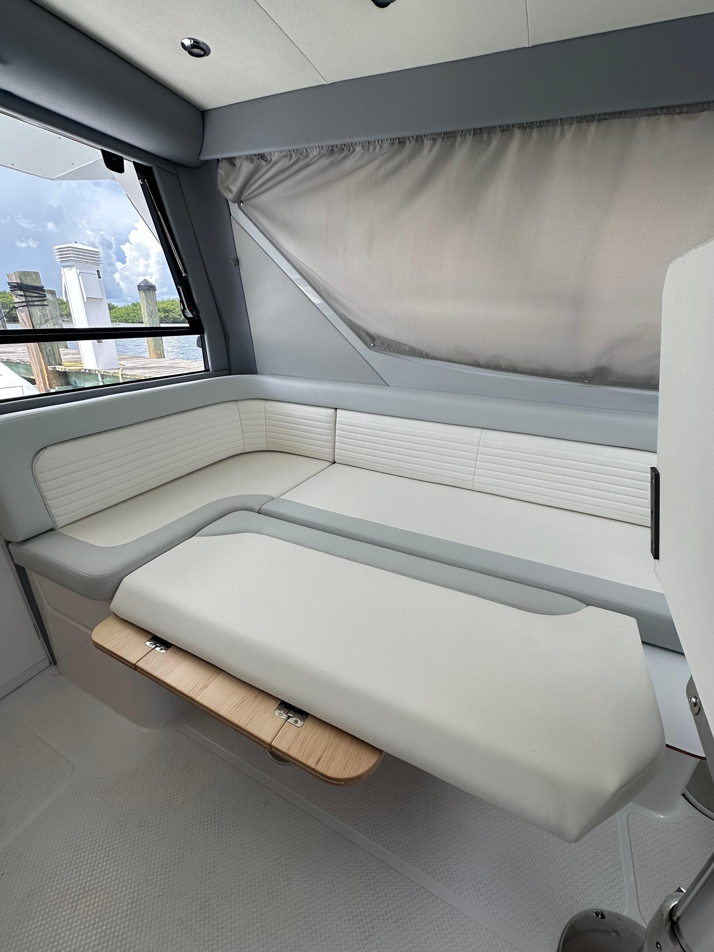 Luxurious interior of 2025 ArrowCat 320 boat with modern seating and sleek design.