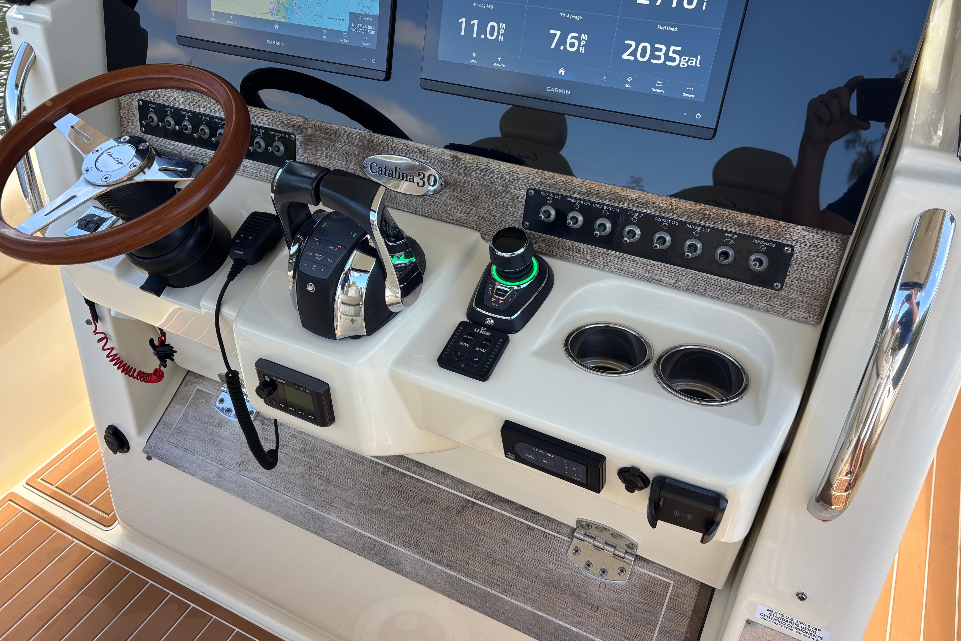 2018 Chris-Craft Catalina 30 helm with steering wheel, controls, and navigation displays.