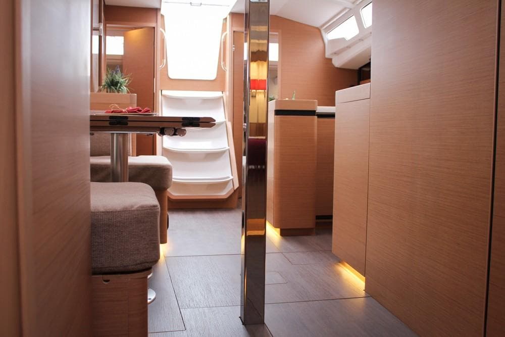Interior of 2025 Jeanneau Sun Odyssey 440 yacht, featuring modern design and cozy seating.