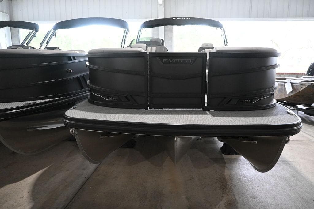 2026 Evotti 723QL pontoon boat in a showroom, showcasing sleek design and modern features.