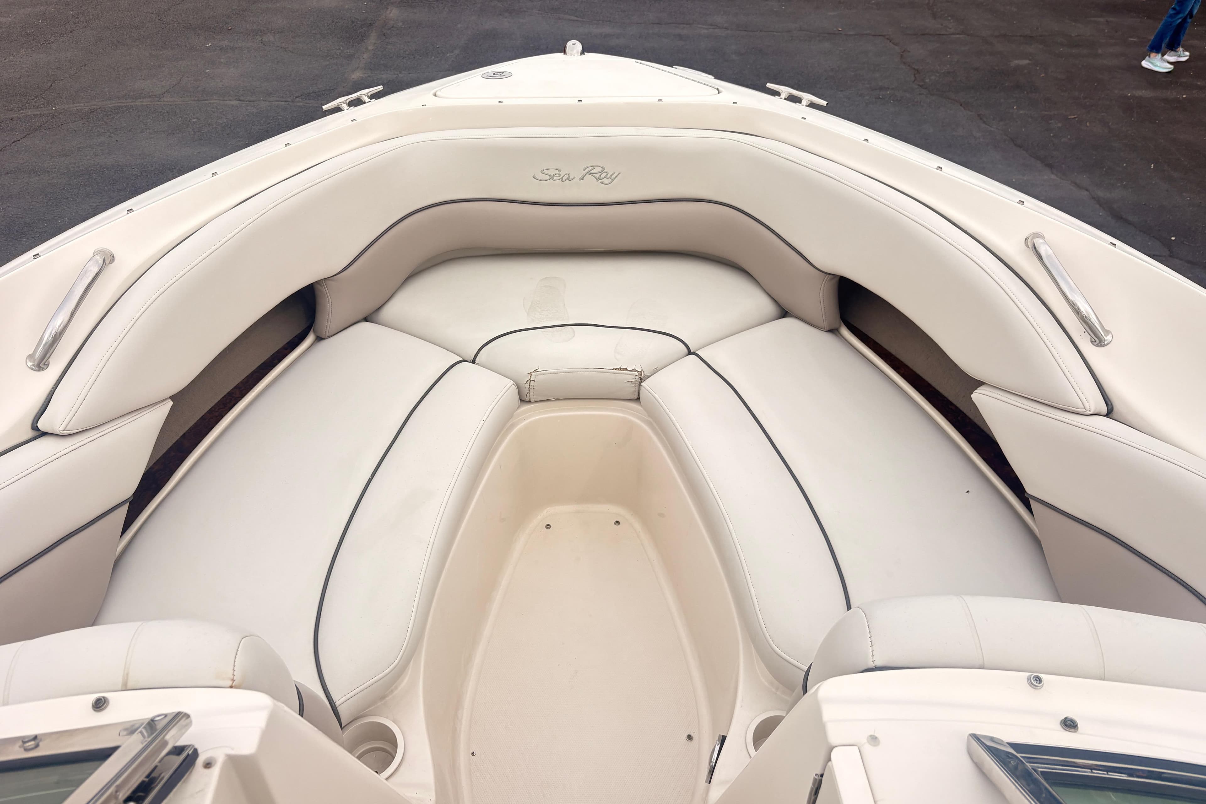 2003 Sea Ray 240 Bow Rider boat interior with white cushioned seating.