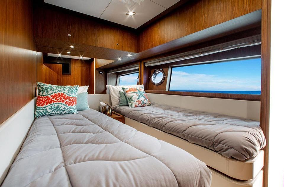 Luxurious twin bedroom on 2017 Riva 88 Domino Super yacht with ocean view.
