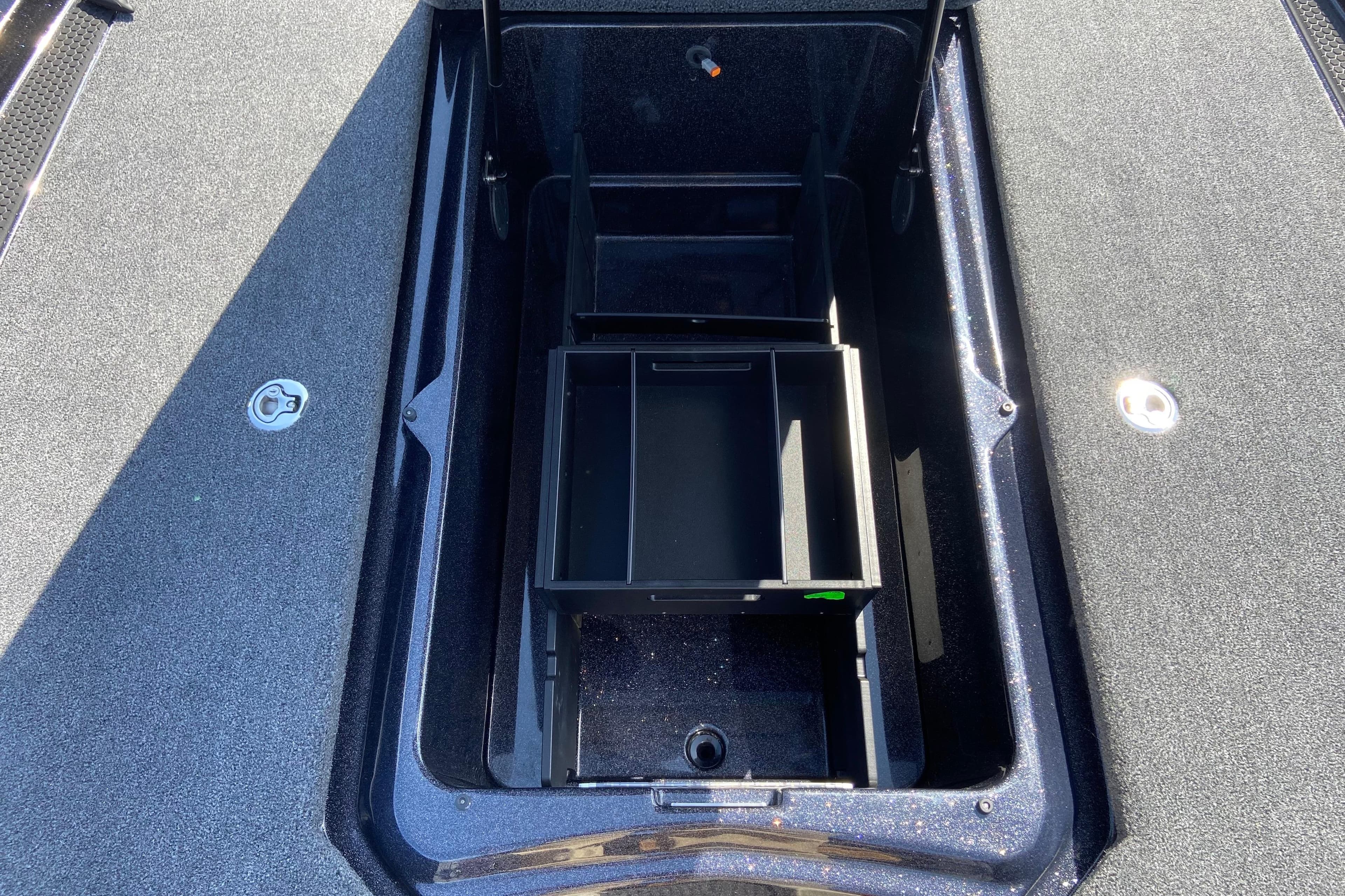 Open storage compartment in 2026 iKon VLX 21 boat, featuring organized interior space.