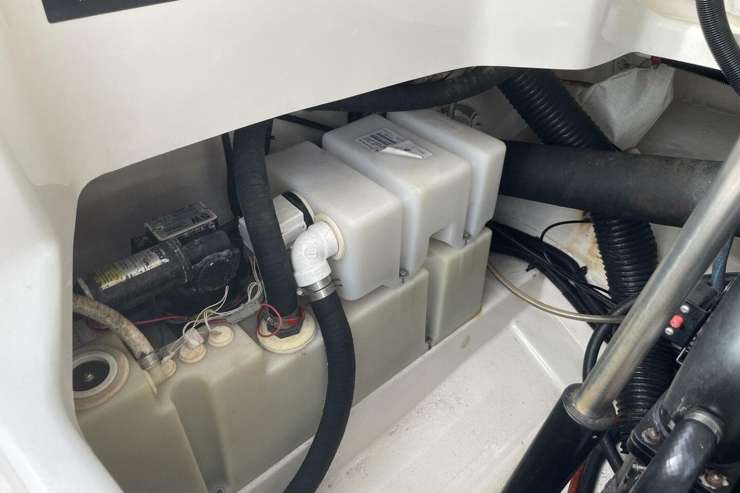 Engine compartment of a 2008 Sea Ray 270 SLX boat, showing hoses and components.