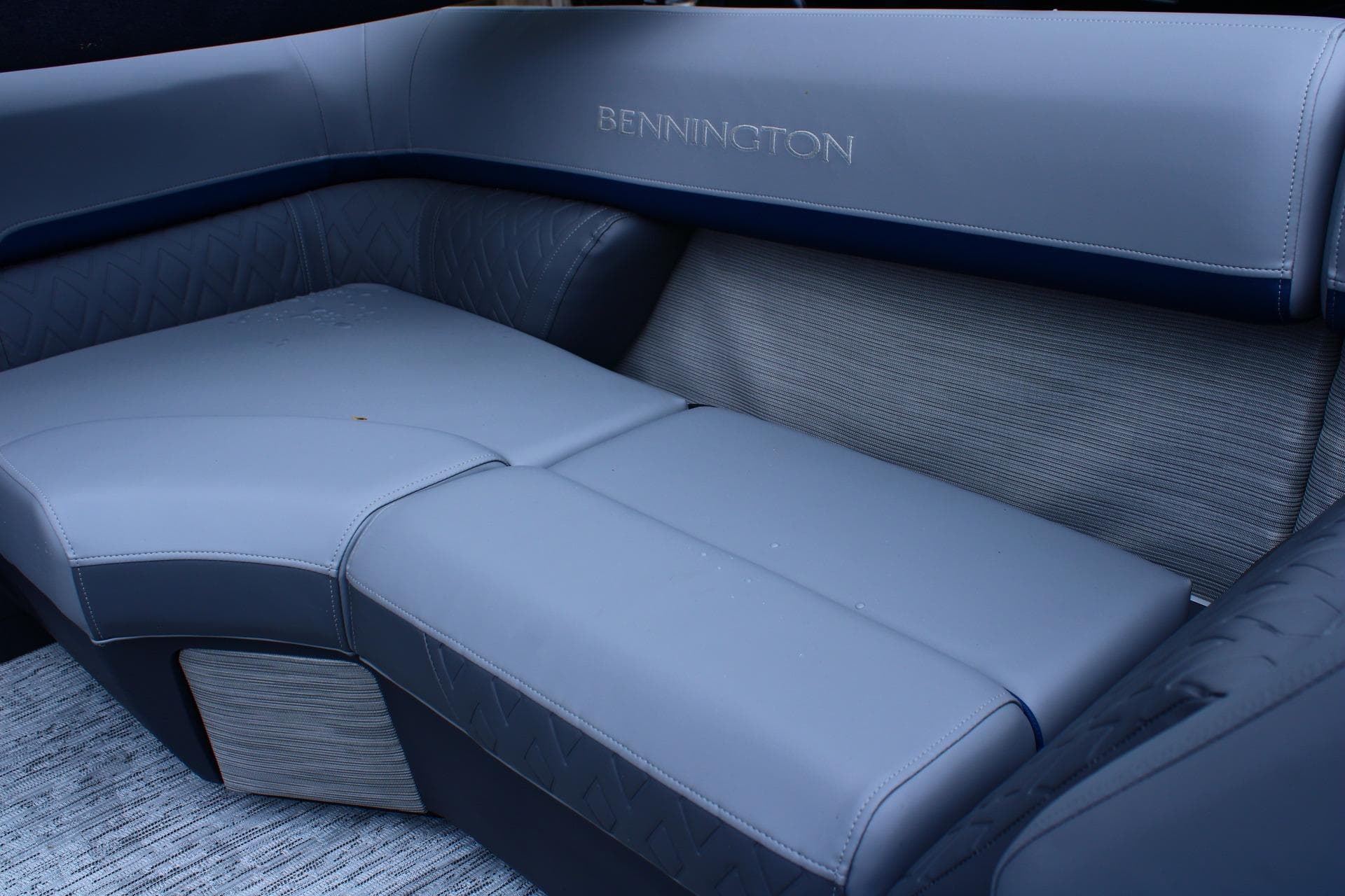 Luxurious seating in the 2026 Bennington 24 MFBSF boat, featuring sleek gray upholstery.