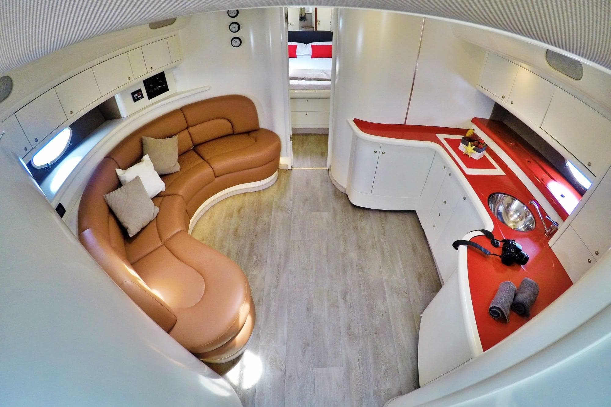 Luxurious interior of 2001 Cranchi Mediterranée 50 yacht with leather seating and modern kitchen.