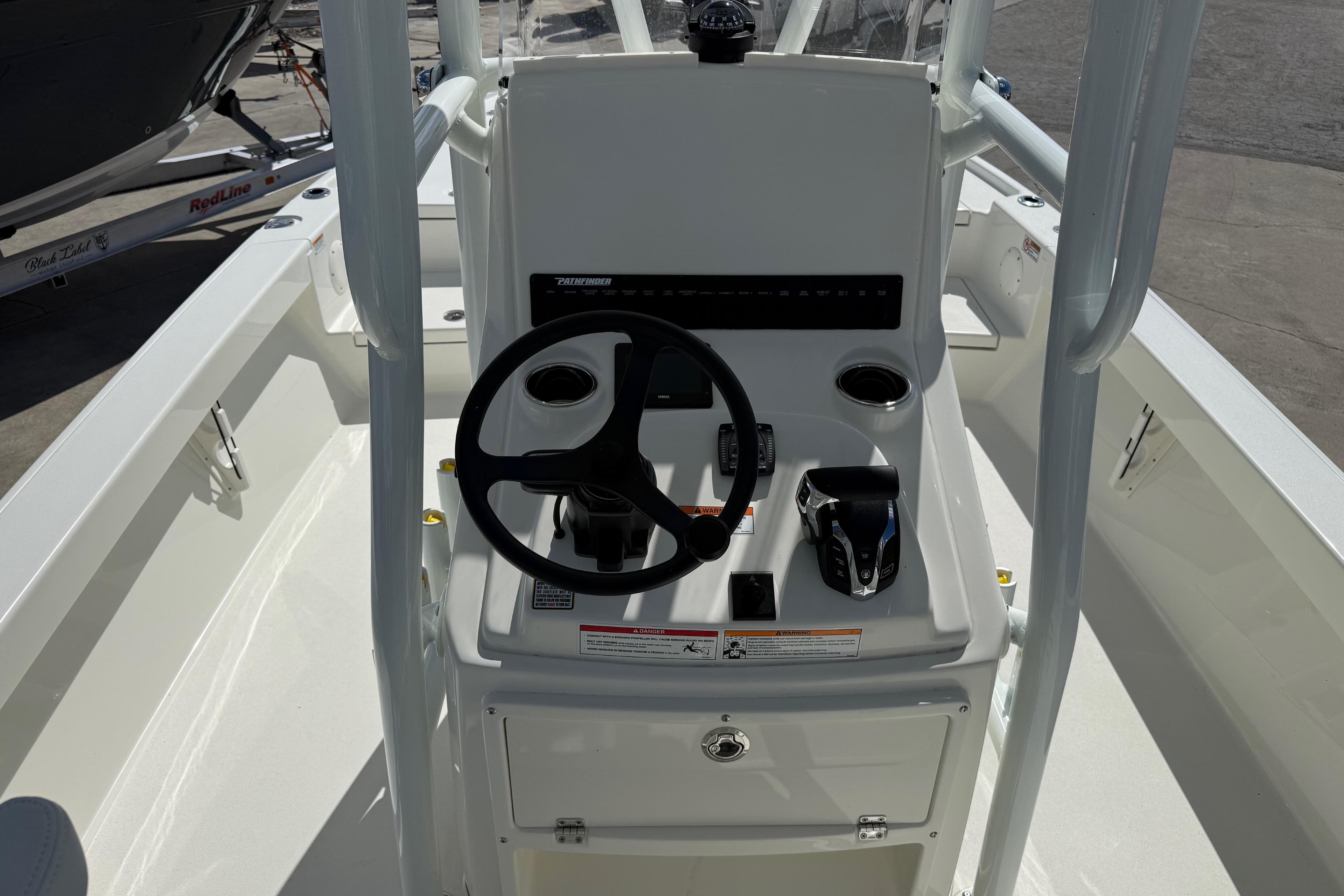 2026 Pathfinder 2500 Hybrid boat console with steering wheel and controls.