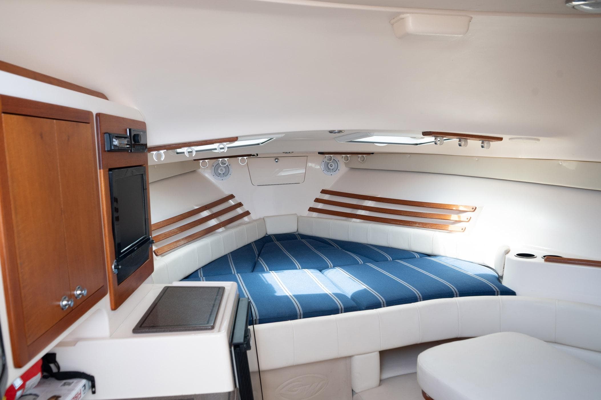 Luxurious interior of 2009 Grady-White Express 330 boat with cozy sleeping area.