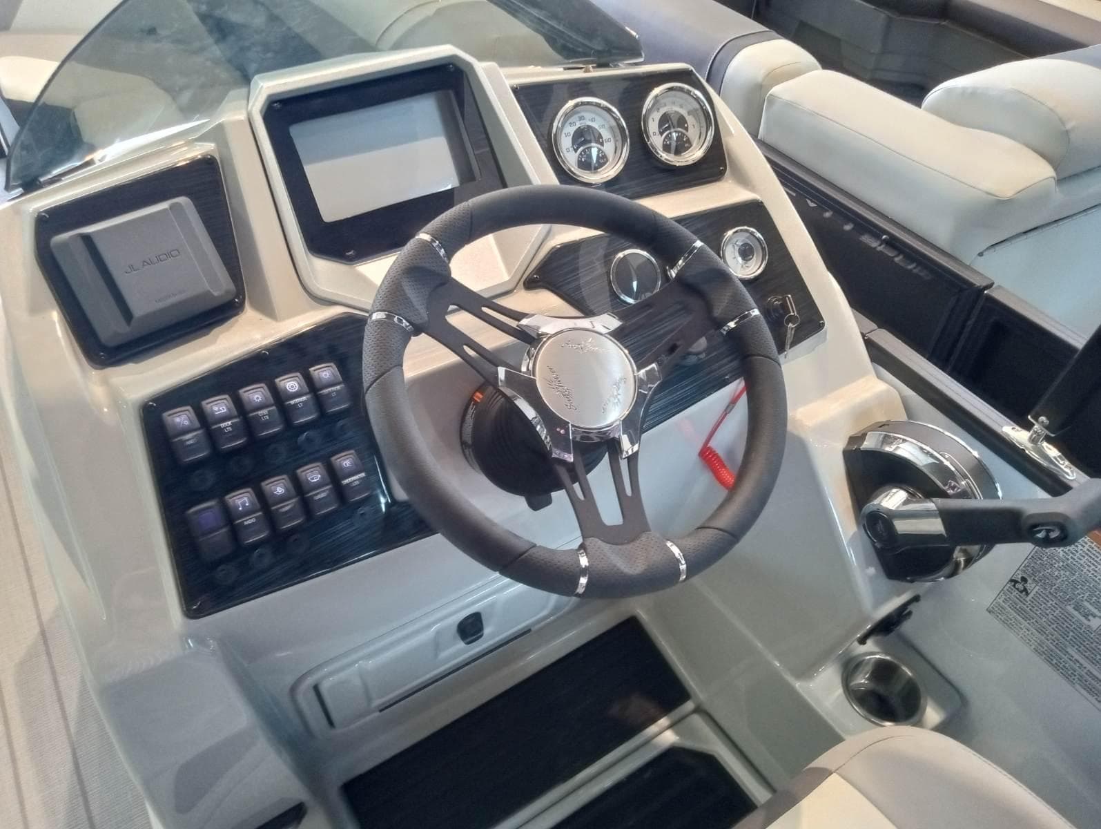 2023 SunChaser Eclipse 8523 LR DH boat dashboard with steering wheel and control panel.