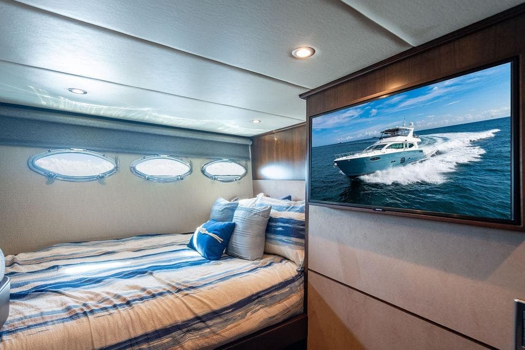 Luxurious Lanzarote Ventuno 73 yacht bedroom with portholes and TV, 2013 model.