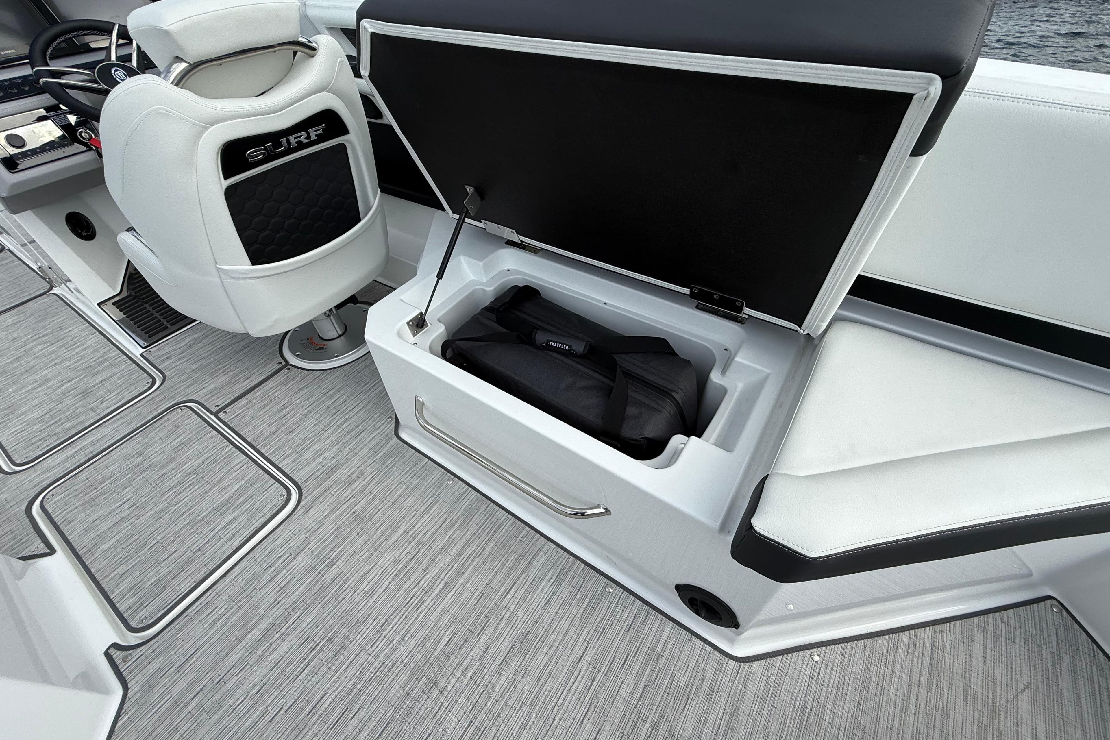 2025 Cobalt R8 Surf boat interior with open storage compartment and seating.