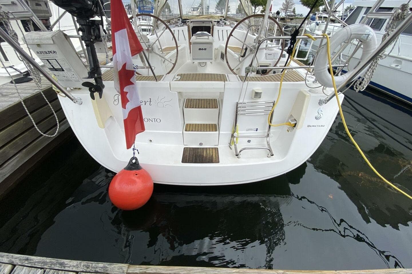 Beneteau 43 sailboat, 2009 model, docked with Canadian flag and safety equipment.