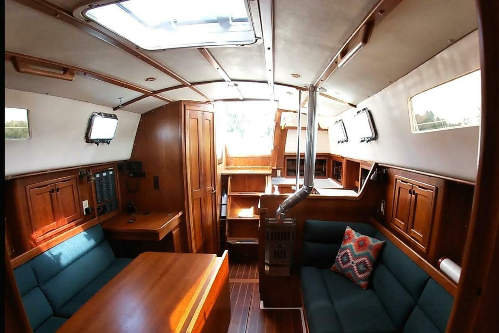 Interior of 2000 Saga 35 sailboat with wood finish and cozy seating area.