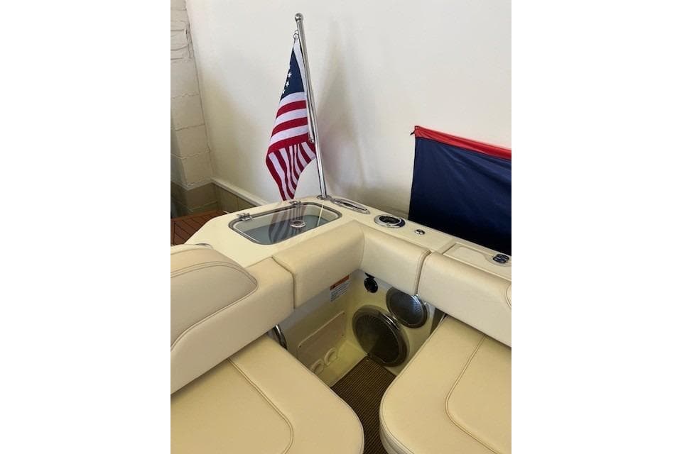 2025 Chris-Craft Calypso 28 boat interior with American flag and seating area.