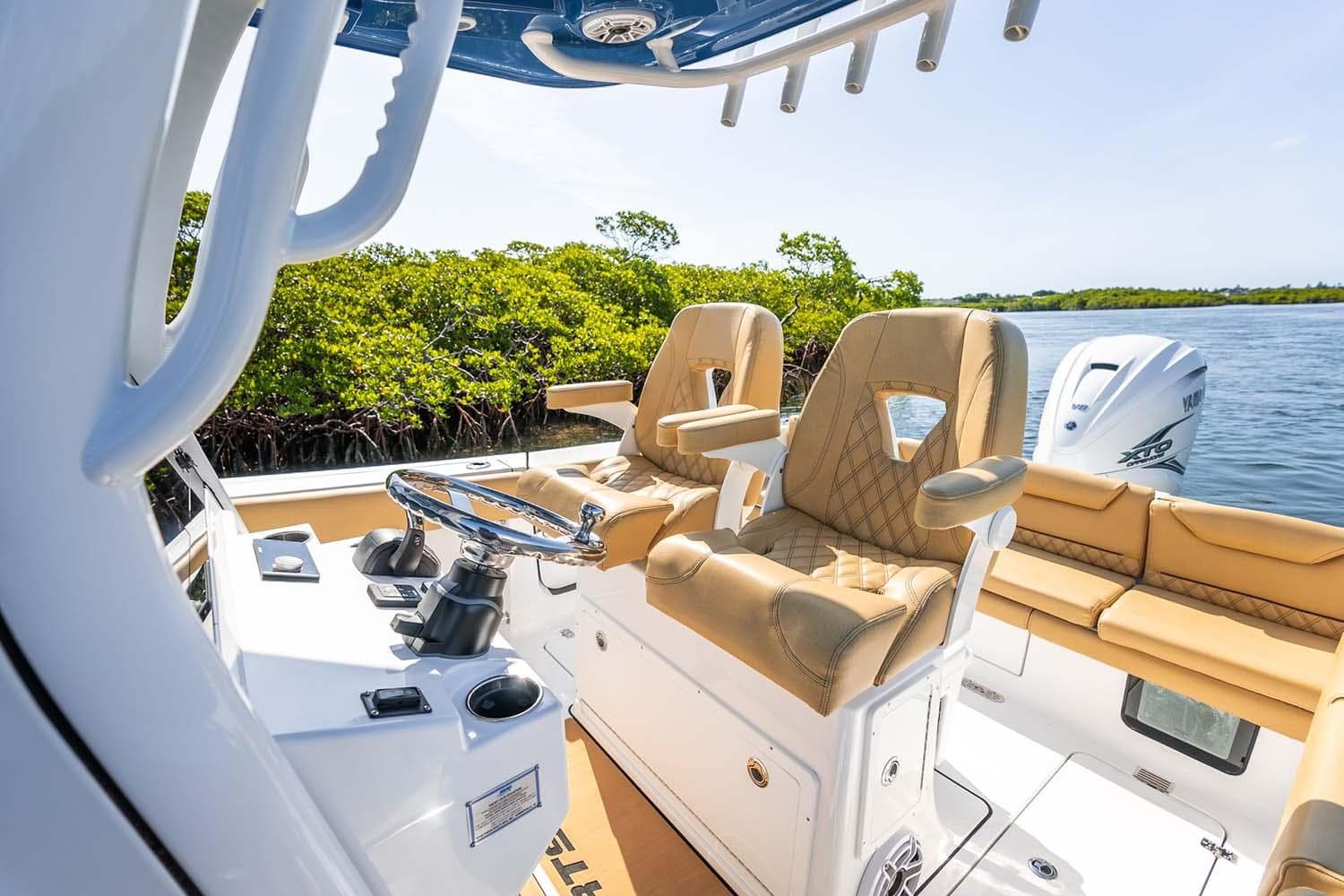 Manufacturer Provided Image: 2025 Sportsman Heritage 261 Center Console boat interior with tan seating and steering wheel.