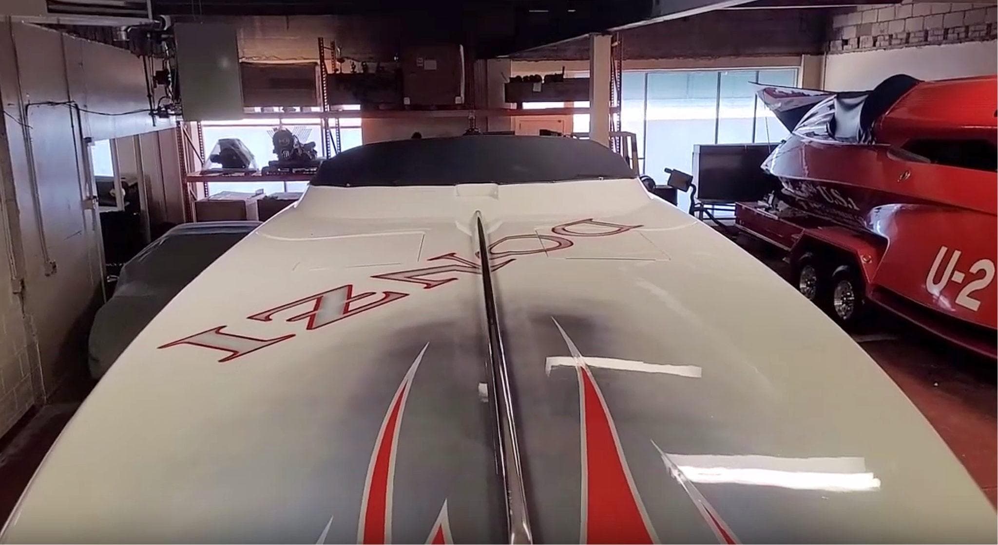 2008 Donzi 35 ZR speedboat in a garage, showcasing sleek design and bold graphics.