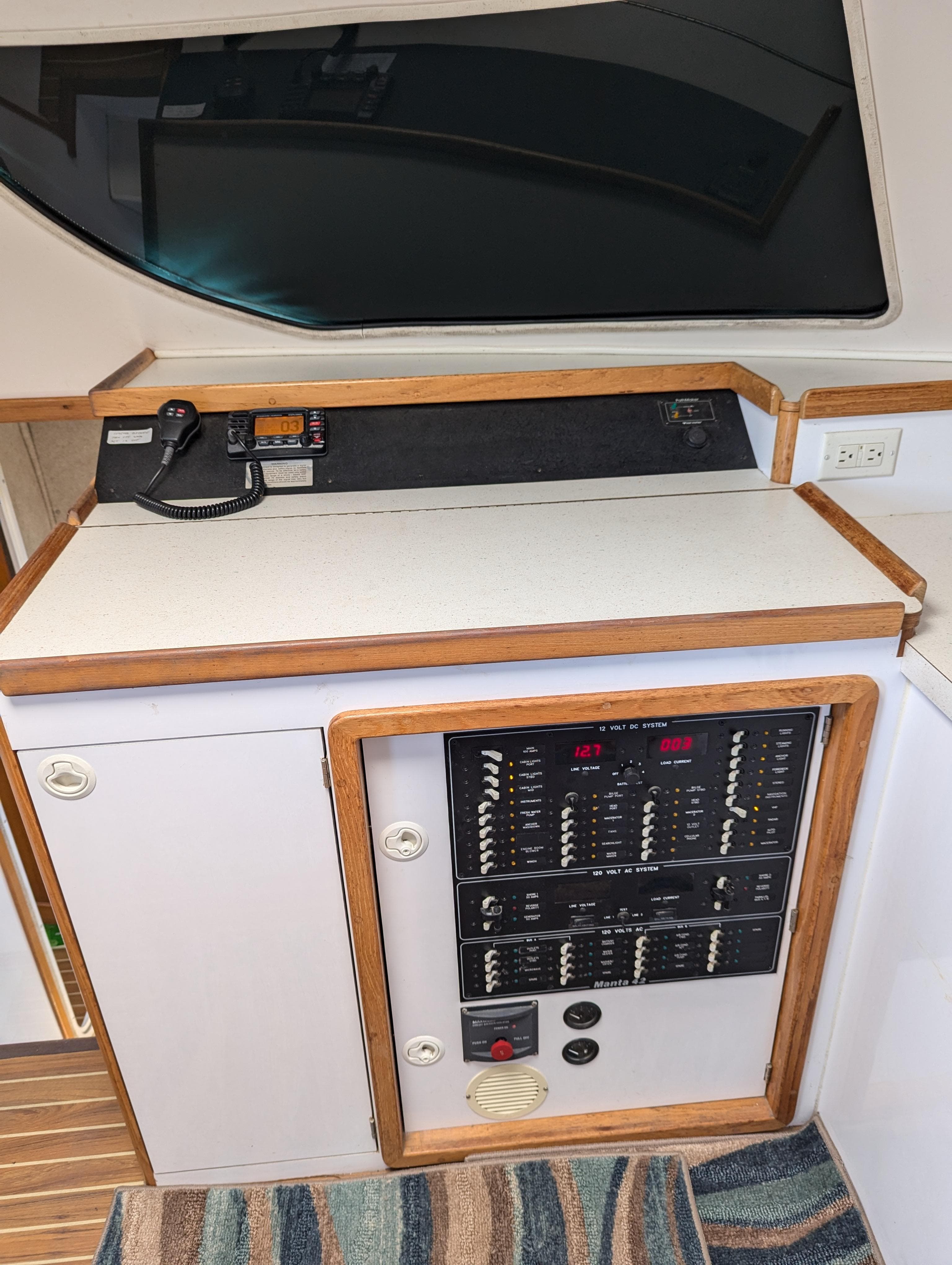 Interior view of a 2000 Manta 42 yacht's control panel and communication equipment.