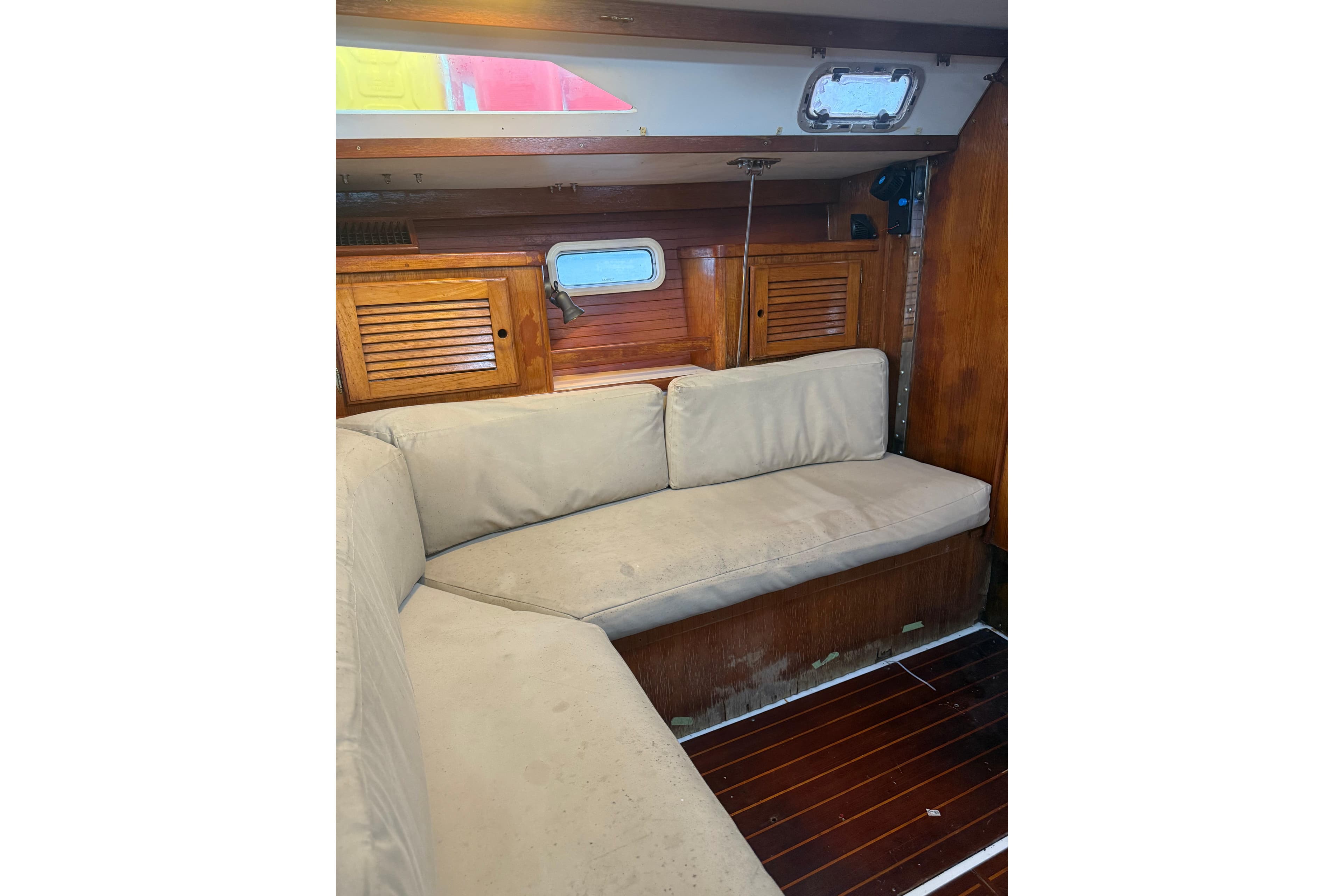 Interior of 1995 Catalina 36 MkII sailboat with beige cushions and wooden cabinetry.