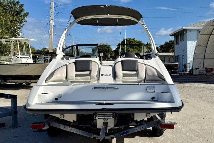 2020 Yamaha AR210 boat with sleek design, parked outdoors under blue sky.
