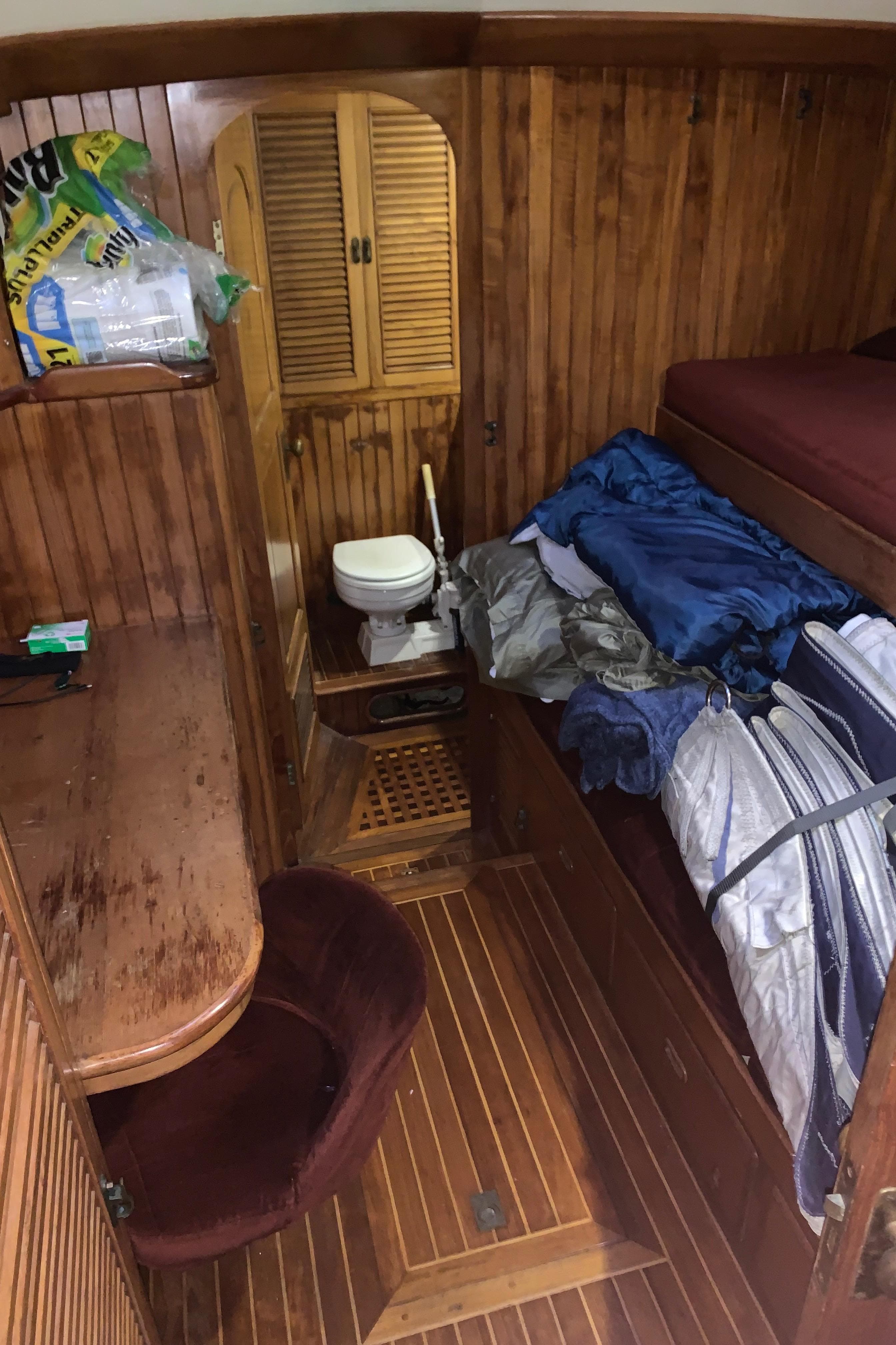 1983 Liberty Center Cockpit interior with wooden paneling, desk, chair, and compact toilet area.