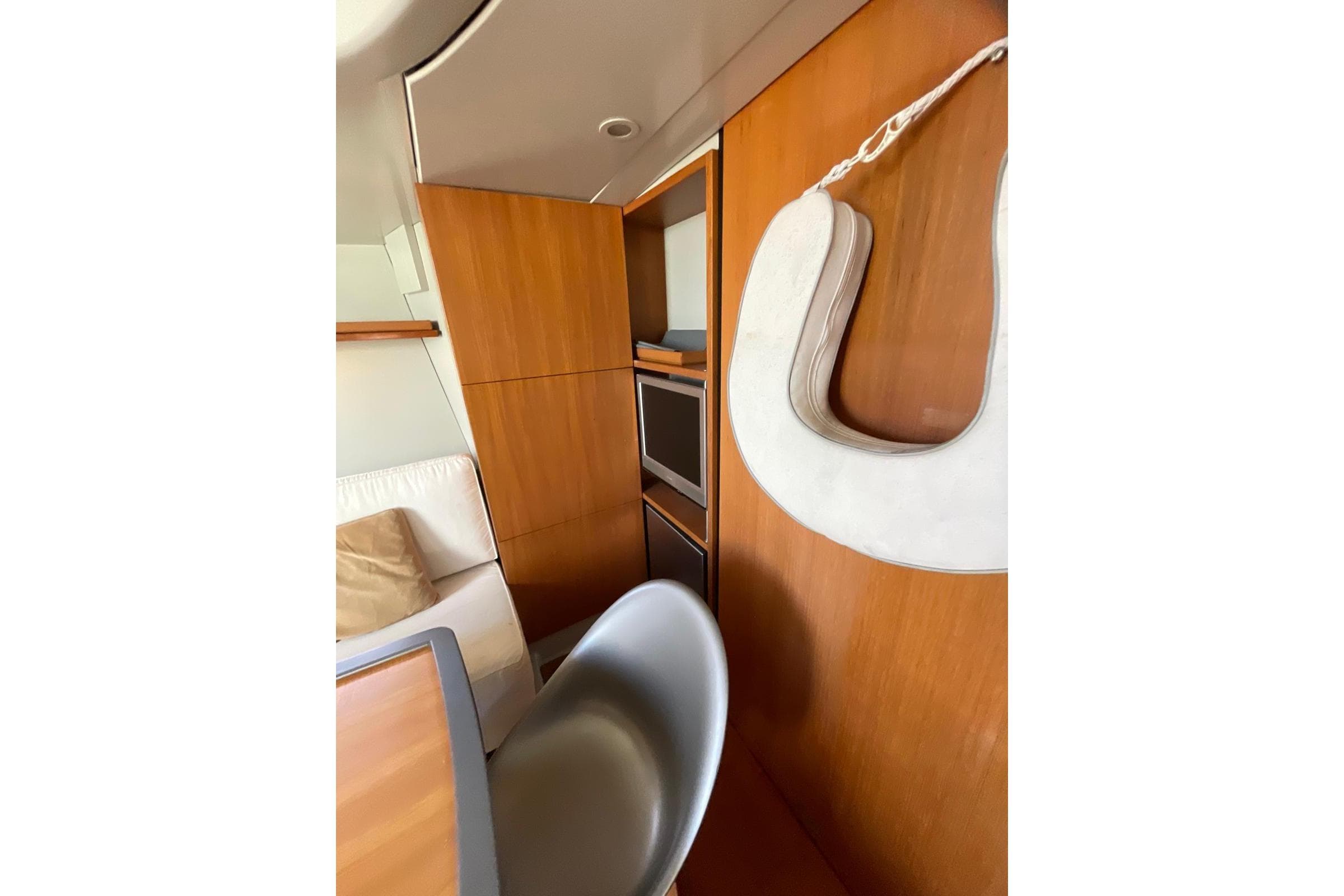 Interior of 2003 Maxi Dolphin 65 yacht with wooden paneling and modern furnishings.