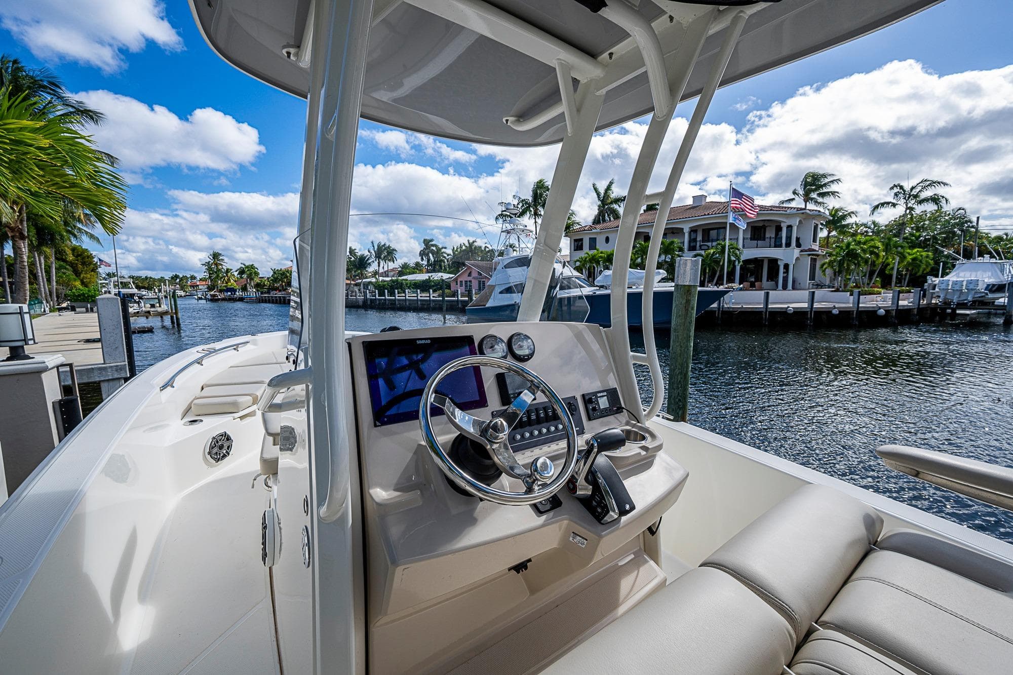 2023 Boston Whaler 250 Dauntless boat interior with steering wheel, dockside view.