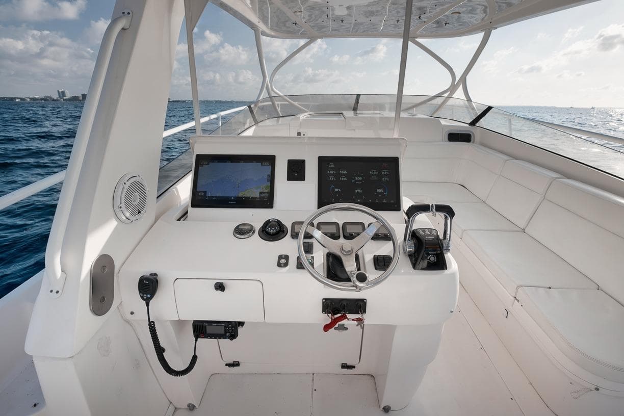 2018 Intrepid 390 Sport Yacht helm with navigation screens and ocean view.
