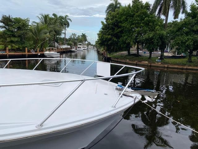 2003 Viking 50 Open yacht docked in a tropical canal.