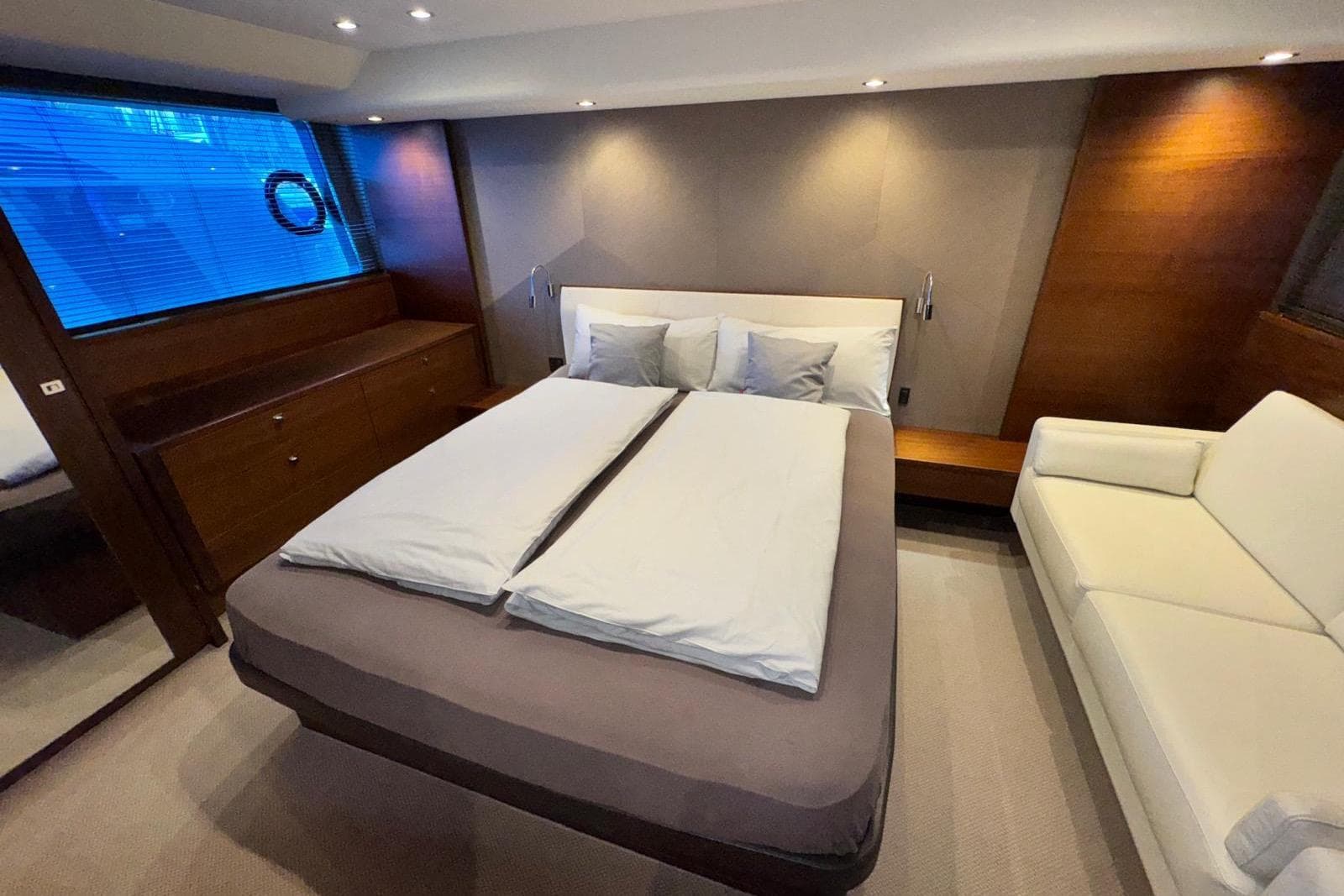 Luxurious cabin interior of 2015 Princess 52 yacht with modern furnishings.