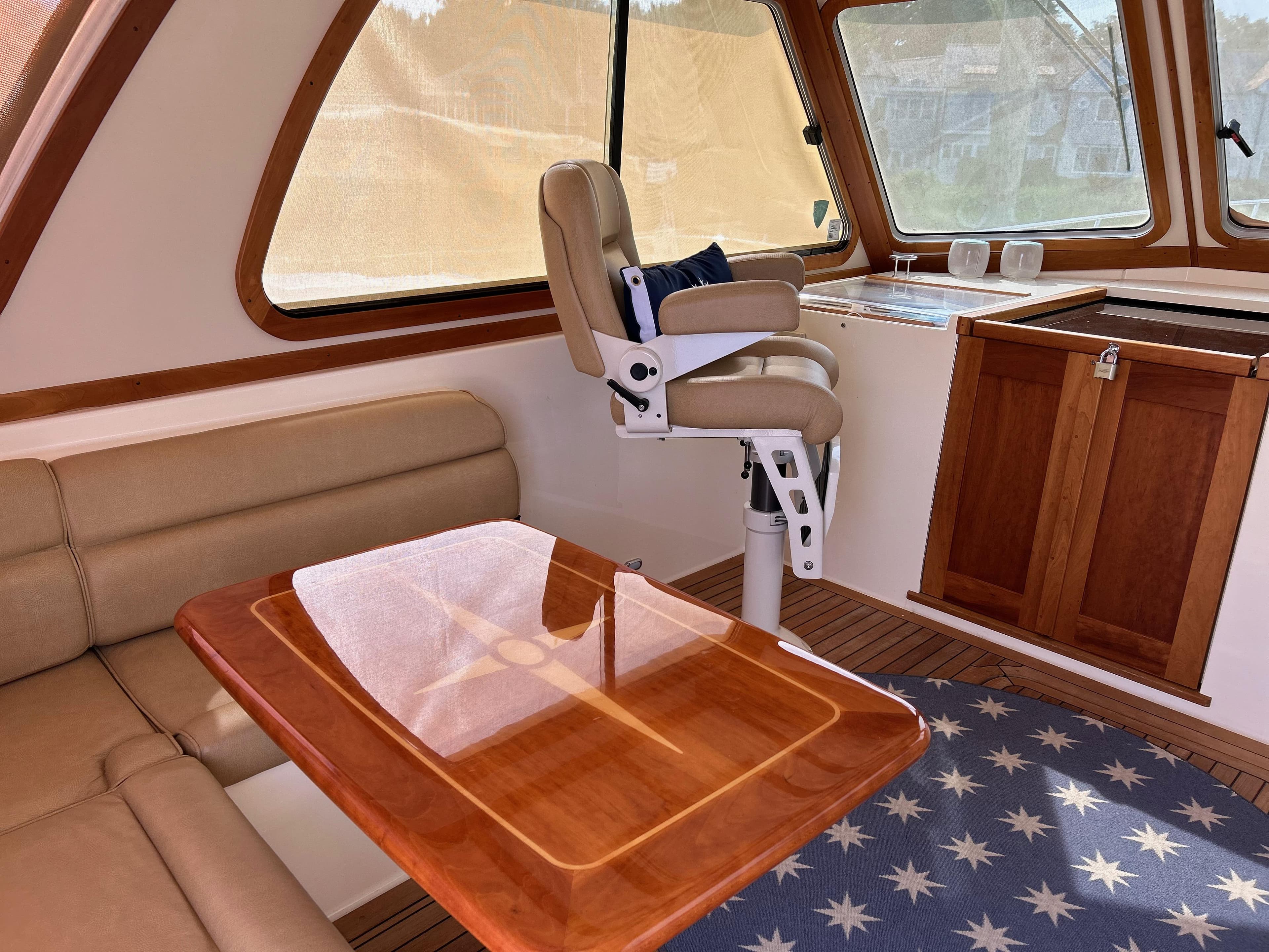 Interior of 2009 Sabre Hardtop Express with leather seating and wooden table.