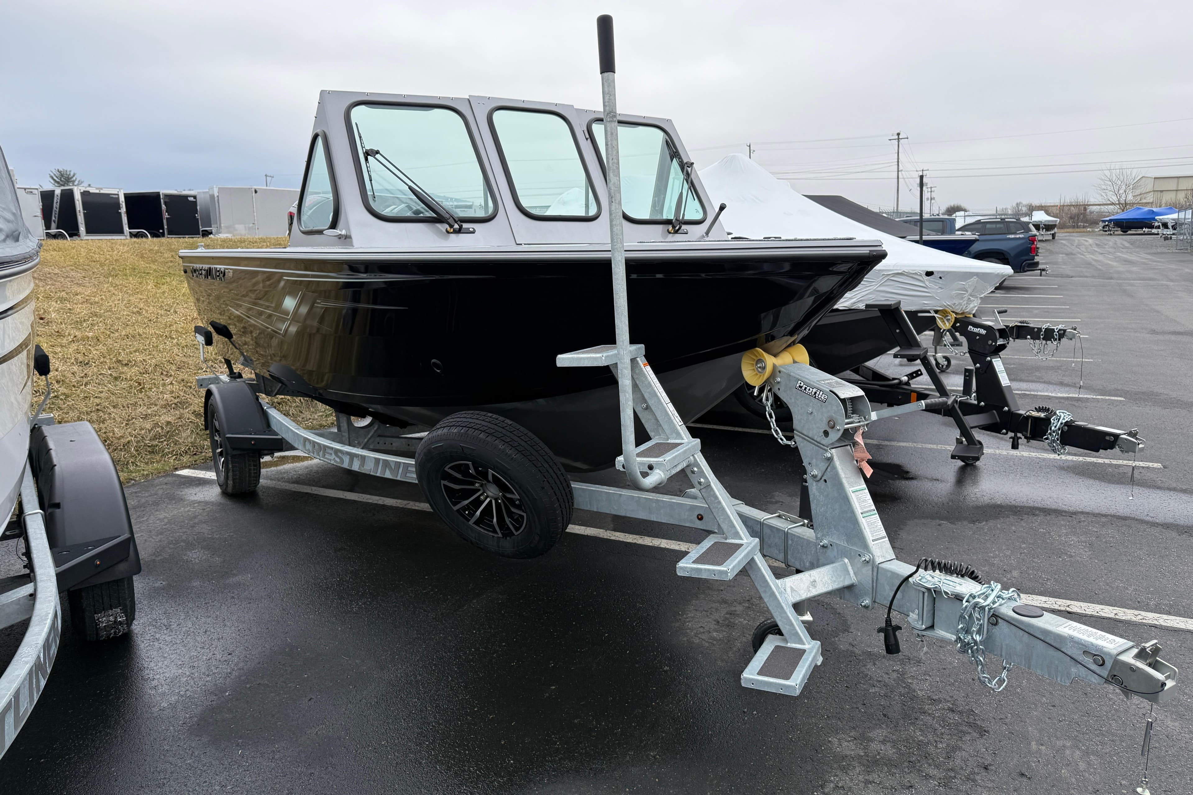 2026 Crestliner 1850 Commander boat on trailer in parking lot.